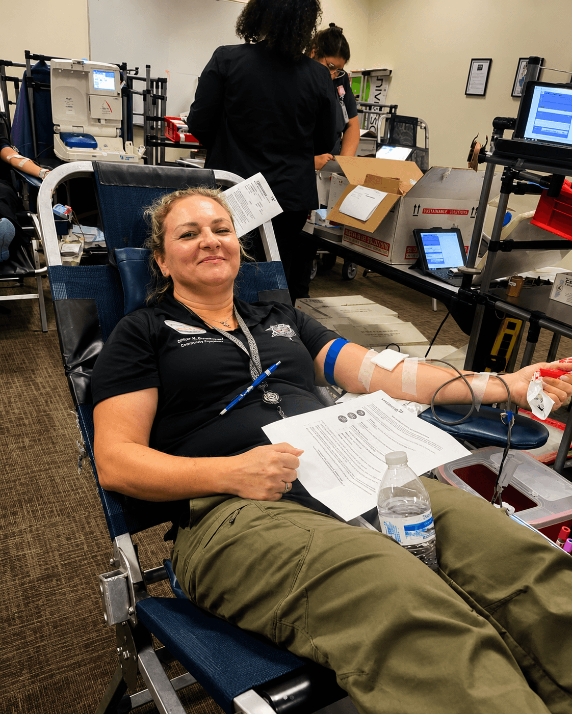 woman donating at blue blood drive