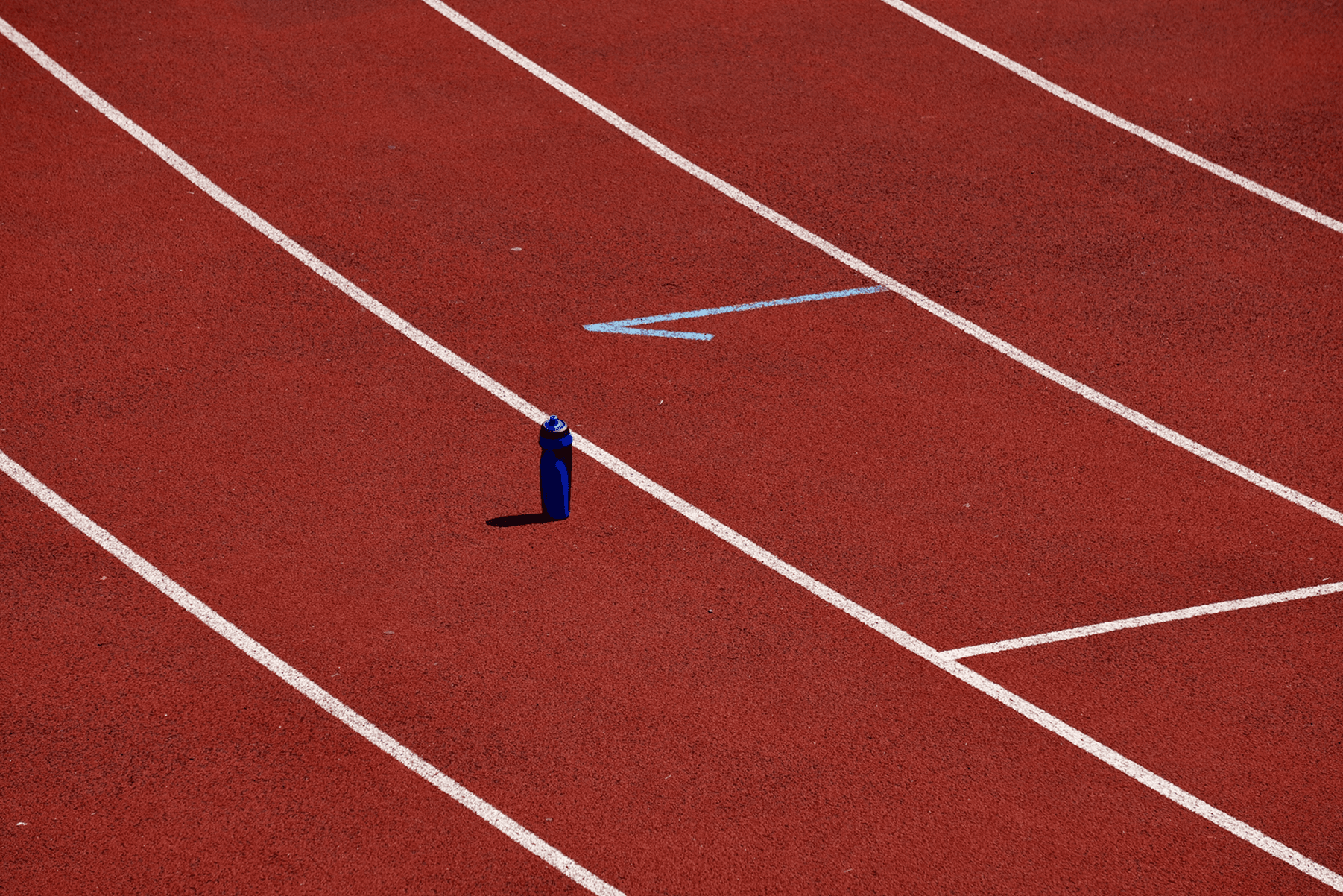 Running track with a water bottle placed on the ground