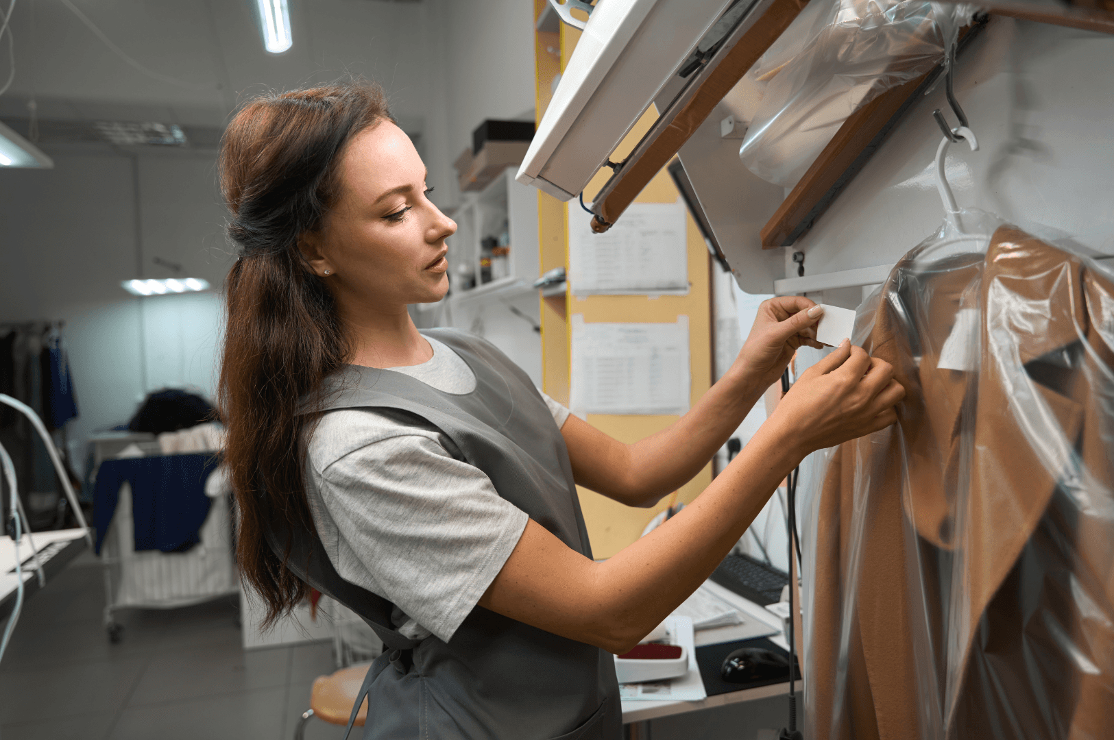 Woman putting a garment tag to a coat