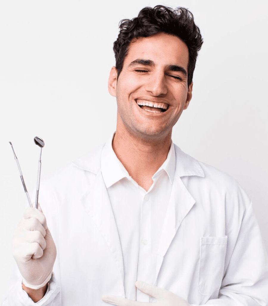 A smiling male dentist holding a dental tool, ready to assist with consultation and diagnosis.