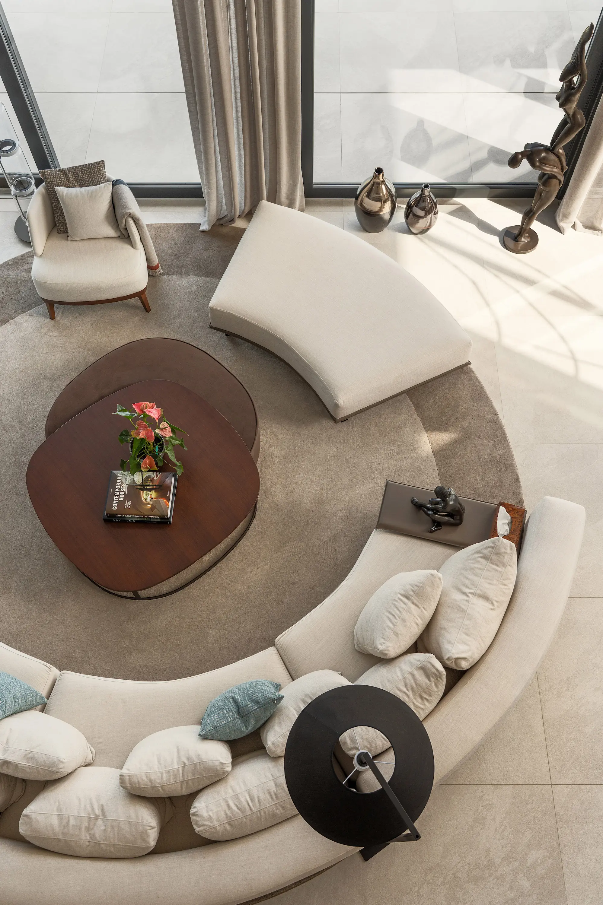 Villa Vista Marbella lounge from above with curved sectional sofa, round coffee table, and circular rug