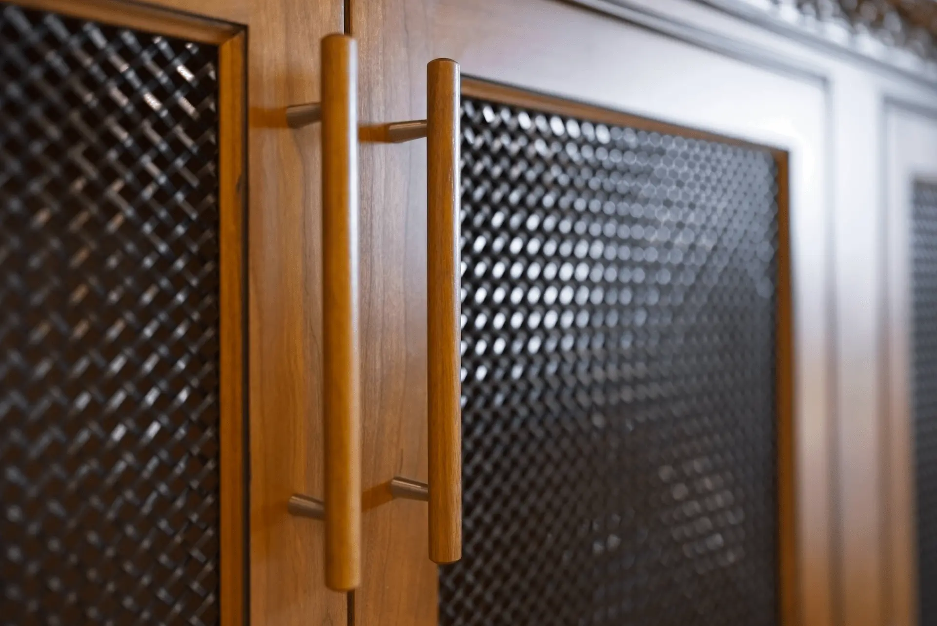 Close-up of the entertainment cabinetry door handles, highlighting the exquisite craftsmanship and attention to detail in the San Juan Capistrano project. Photo by Todd Huge.