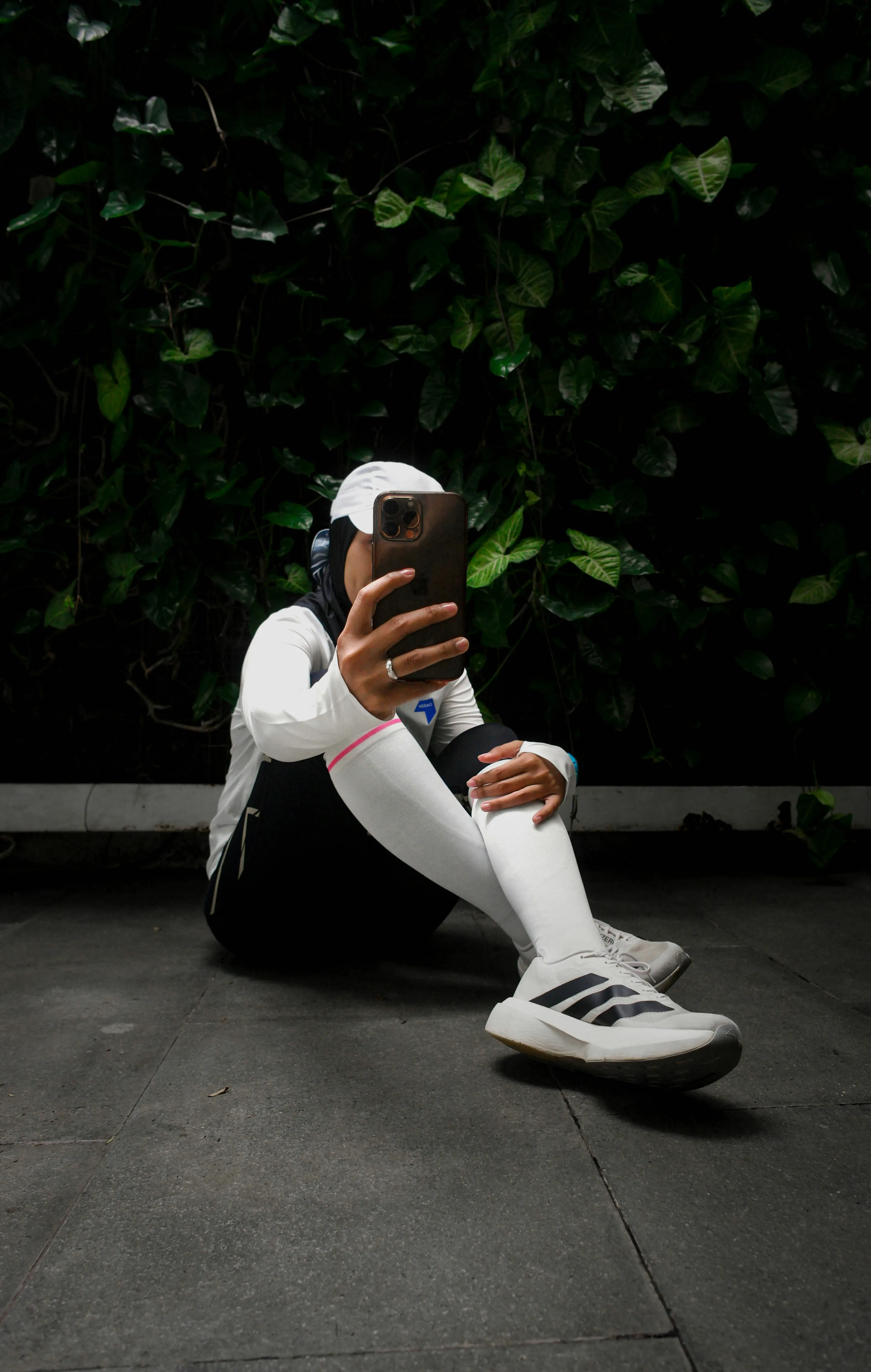 Woman in athletic wear taking a selfie outdoors