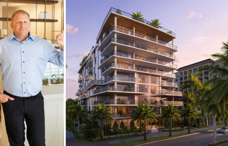 Tall modern skyscraper with vertical lines, viewed against a clear blue sky.