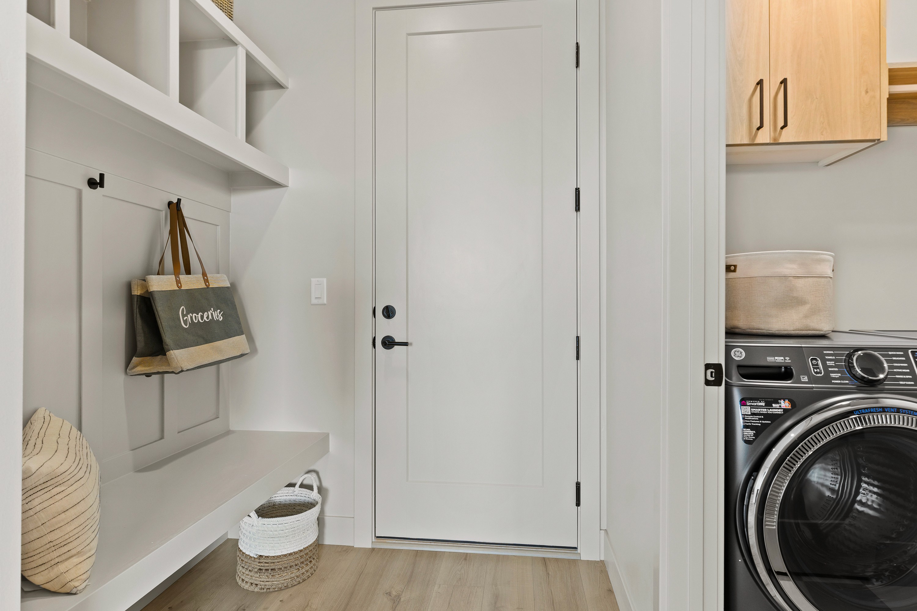 Garage entry mudroom in the BYSO House in Hurricane, Utah featuring a custom bench and storage solutions.