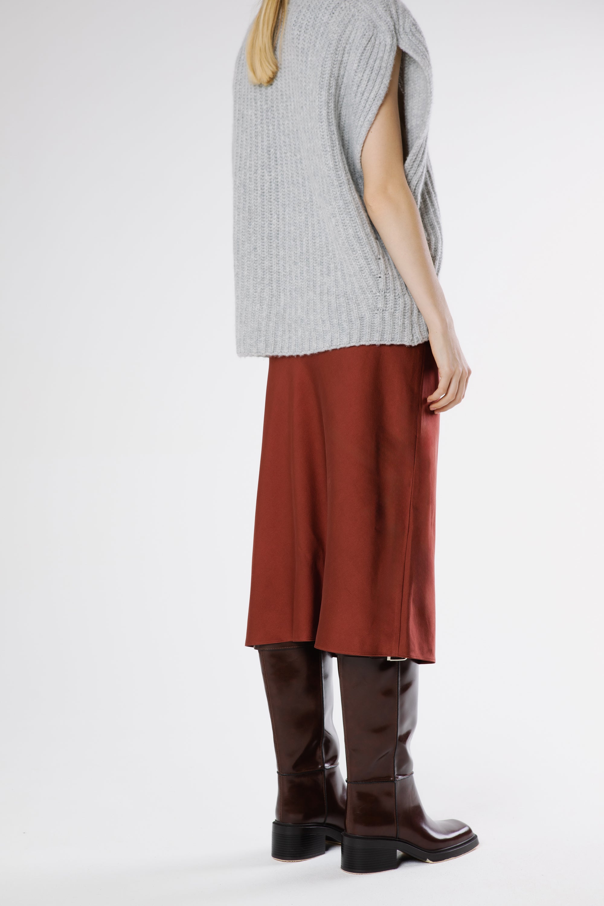 Back view of the Russet heavy silk satin skirt highlighting its fluid movement and minimalist cut.
