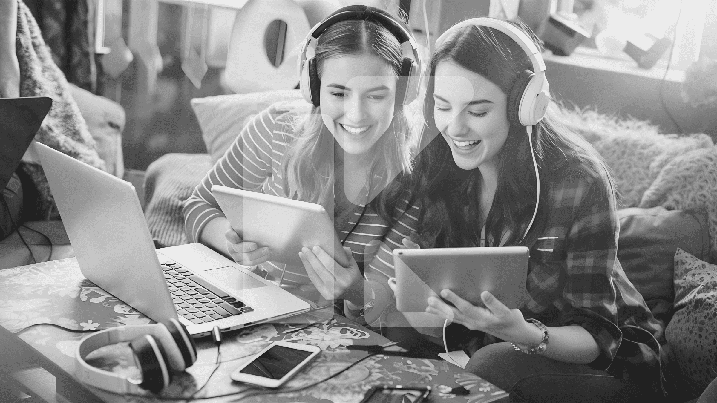 KlassOnline logo watermark over two students learning together with tablets and a laptop