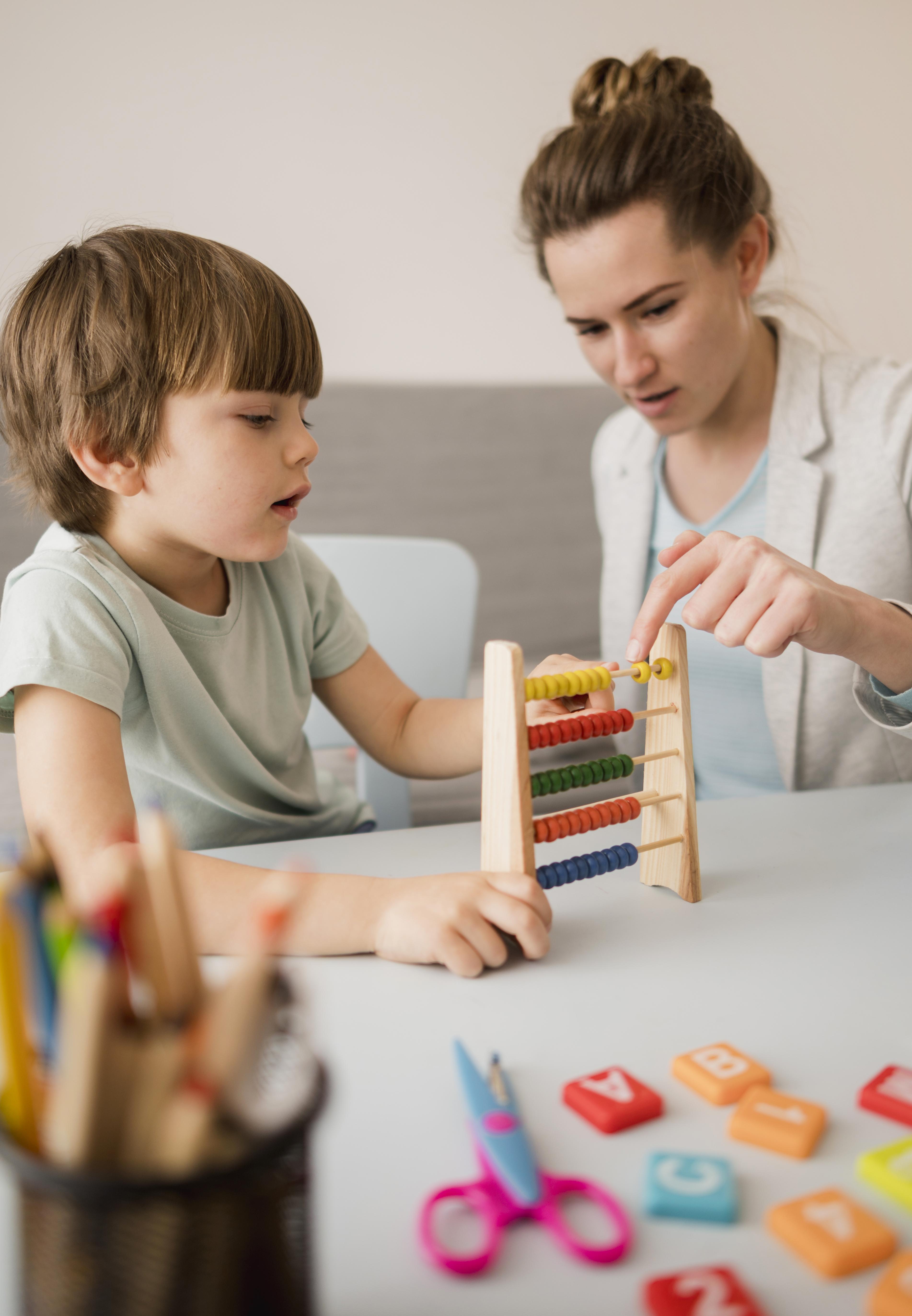 A Therapist and a kid playing games and working on welnness during a play therapy session in Texas