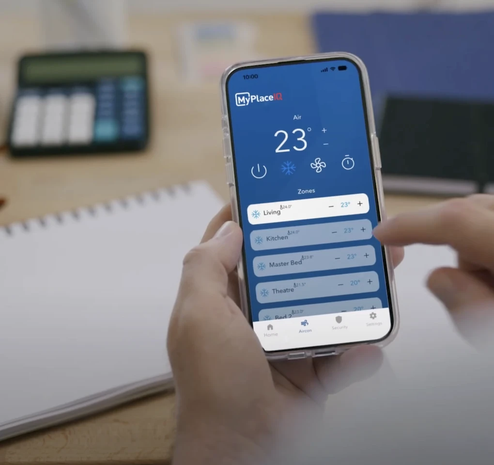 MyPlaceIQ smart air conditioning app displayed on a smartphone, allowing remote control of ducted air conditioning zones to help reduce energy use and power bills.