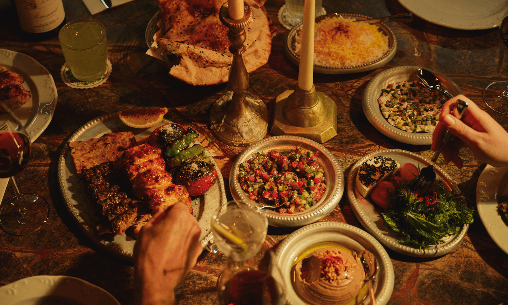 Official Berenjak food photograph published with the Chicago opening announcement, showing kababs, flatbread and shared dishes