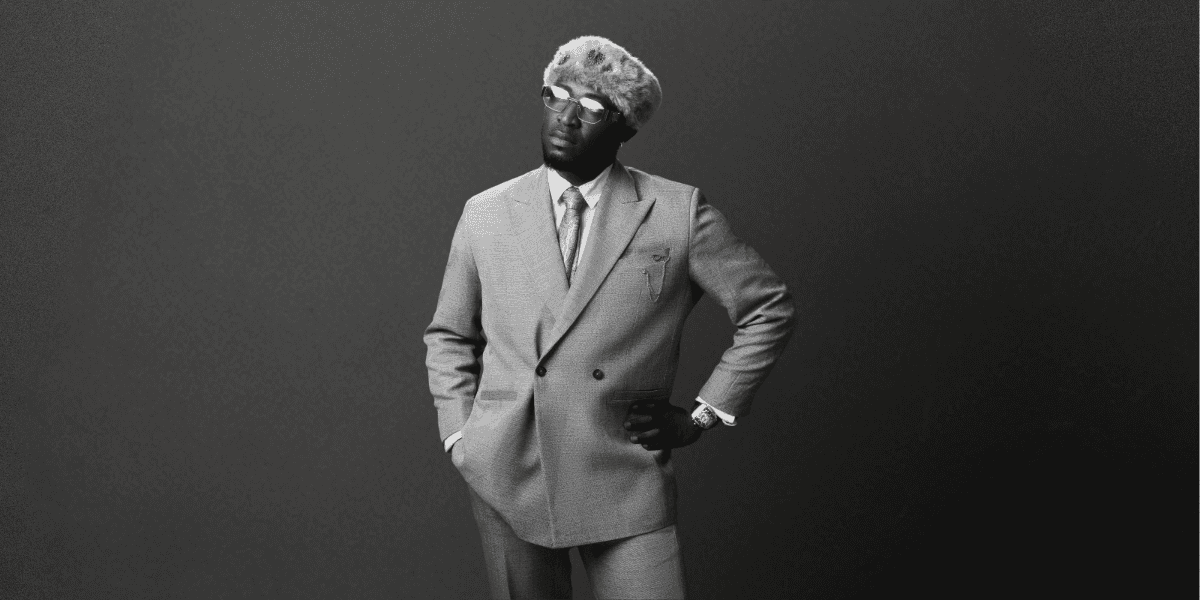 EnergyBank in a stylish suit, embodying his cultural impact as a global artist and the vision behind his music.
