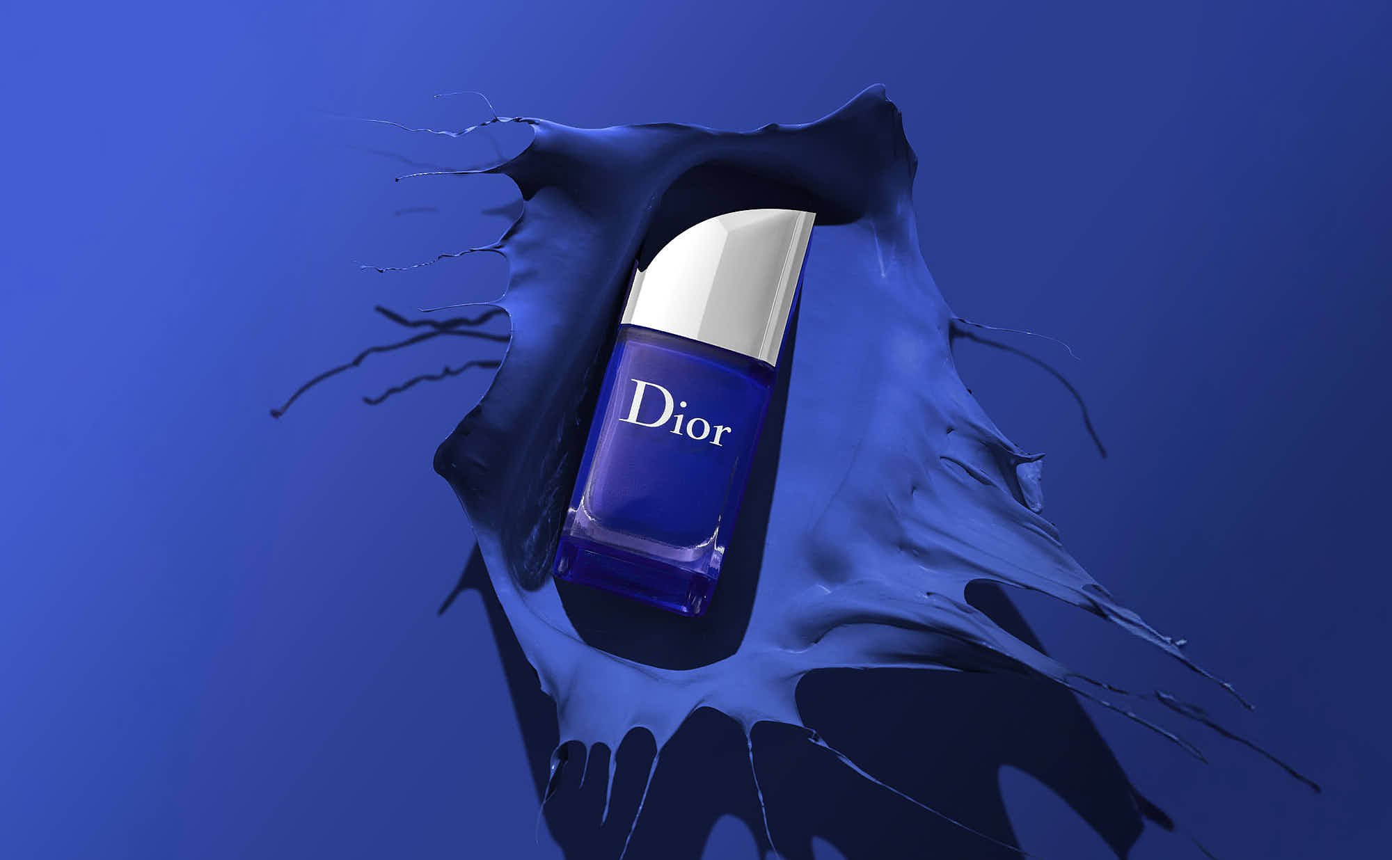 A bottle of skincare product emerges from a deep blue backdrop, surrounded by flowing, abstract shapes.