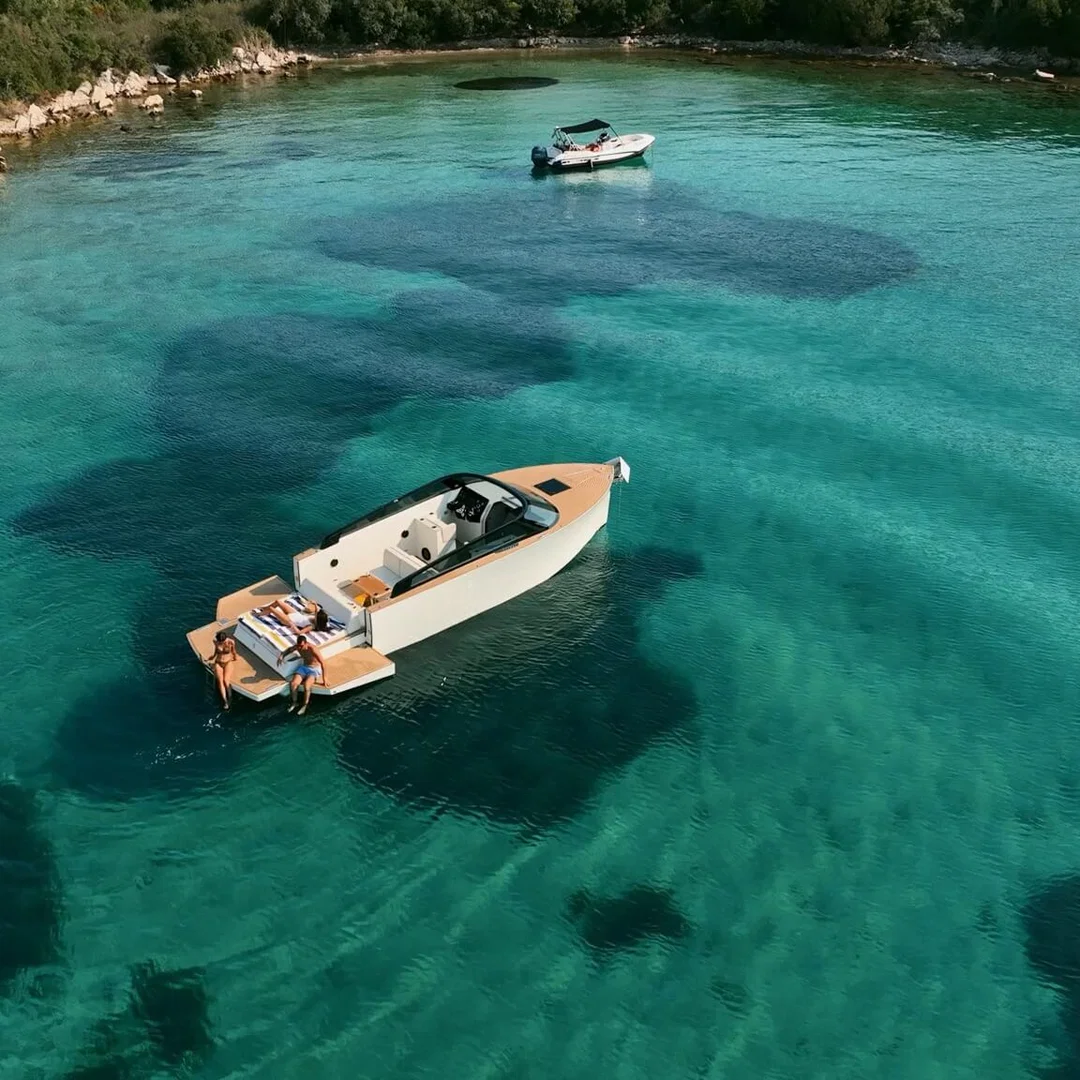 A small boat moored in a clear turquoise cove