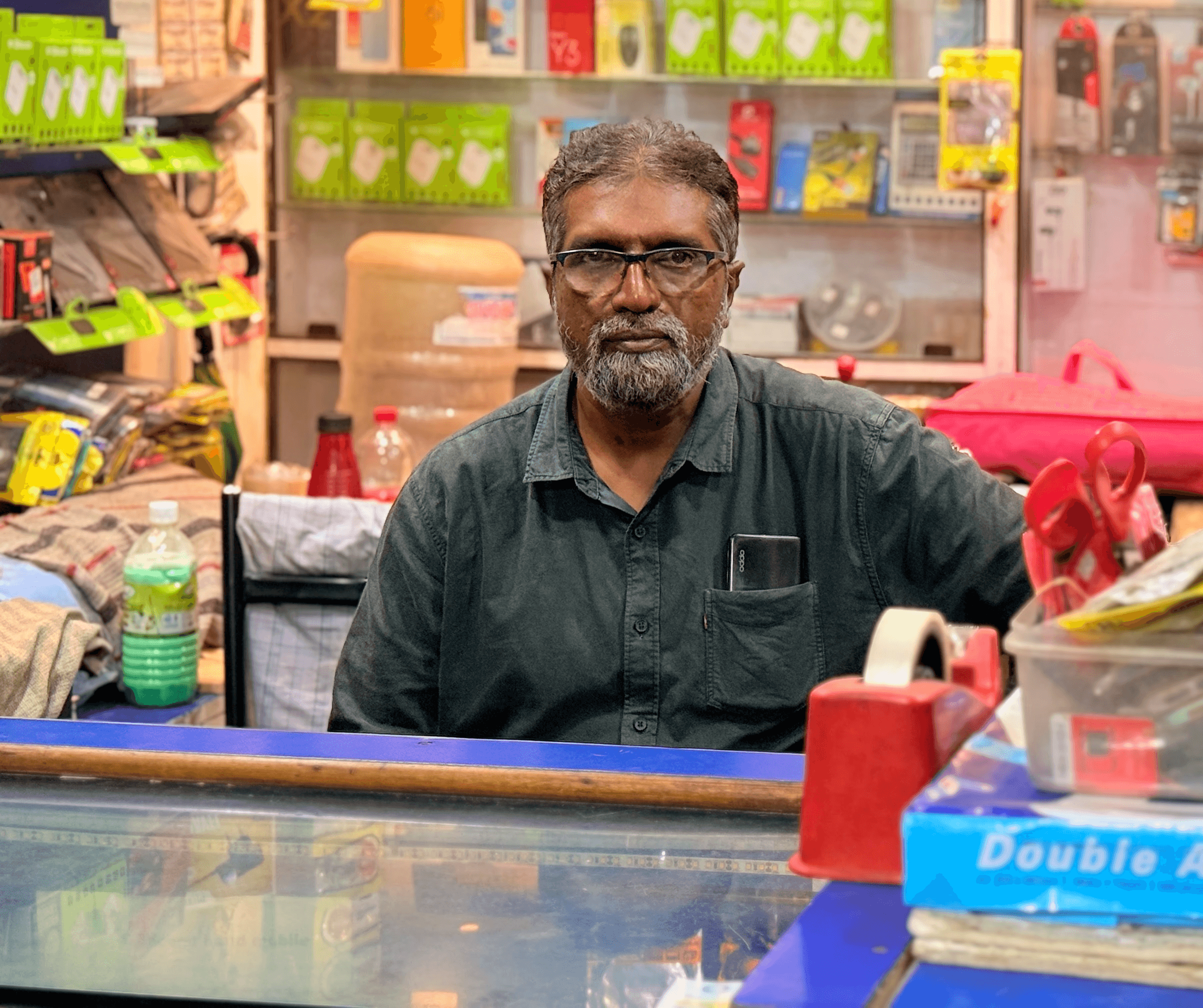 An image of a Shop keeper with his shop