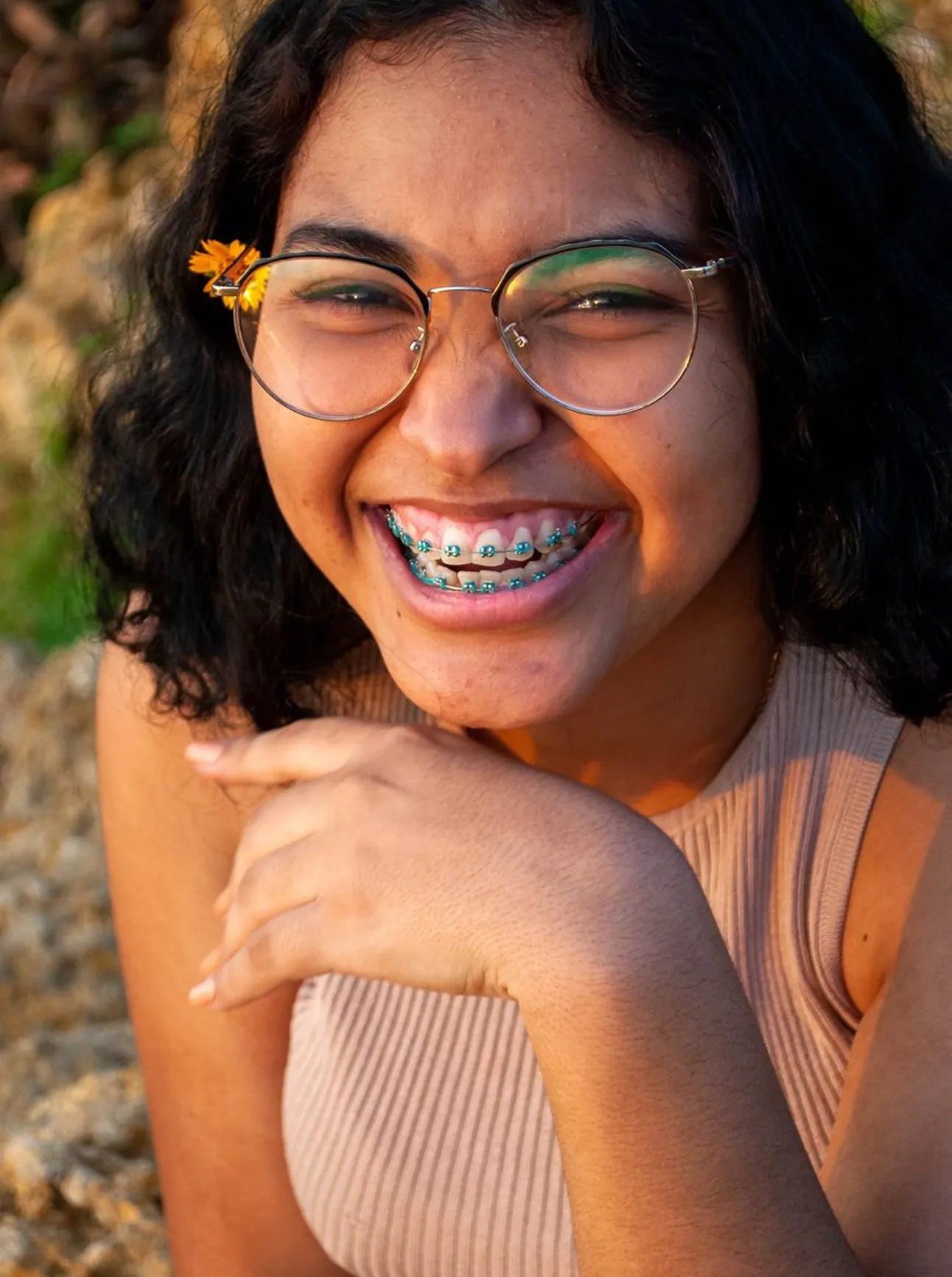 a young woman smiling showing teeth