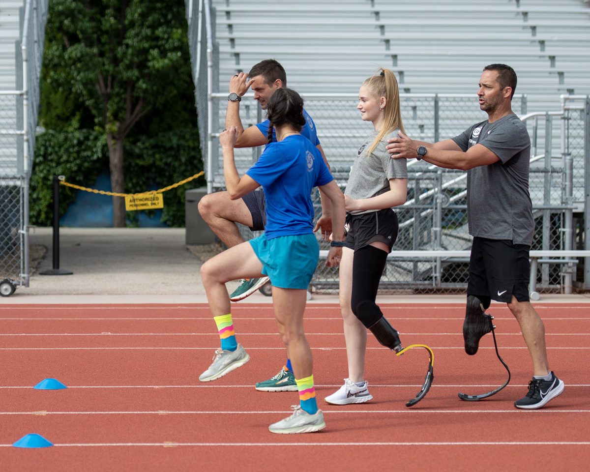 Lilianna Bridge works with trainers to learn how to use her new prosthetic.