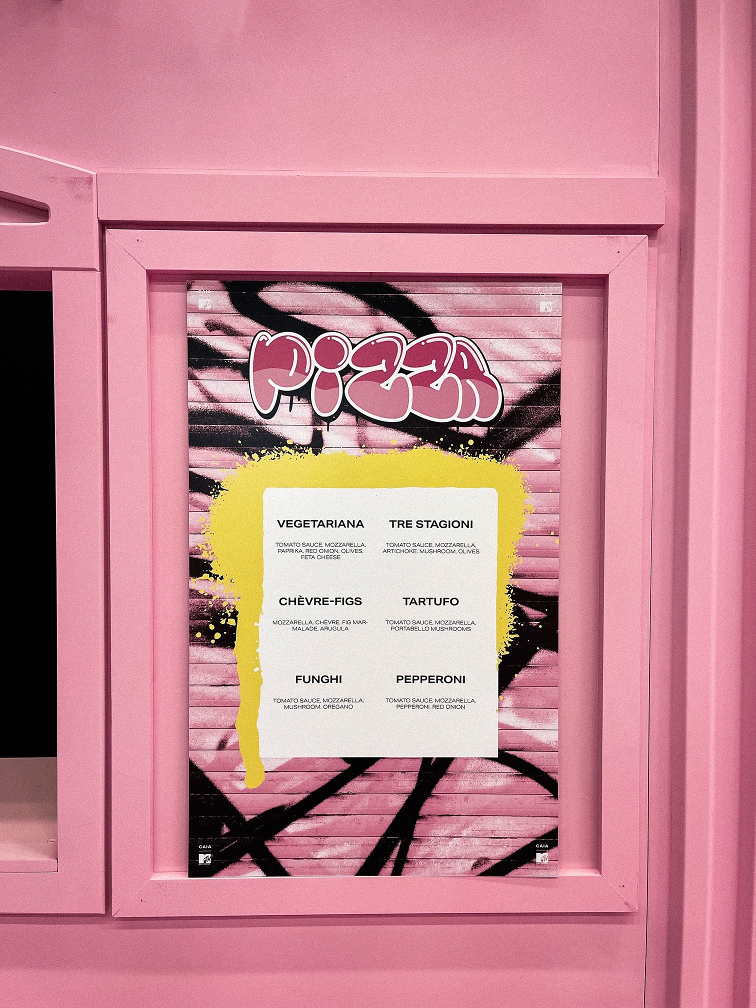 The CAIA and MTV pizza menu displayed within a pink window frame