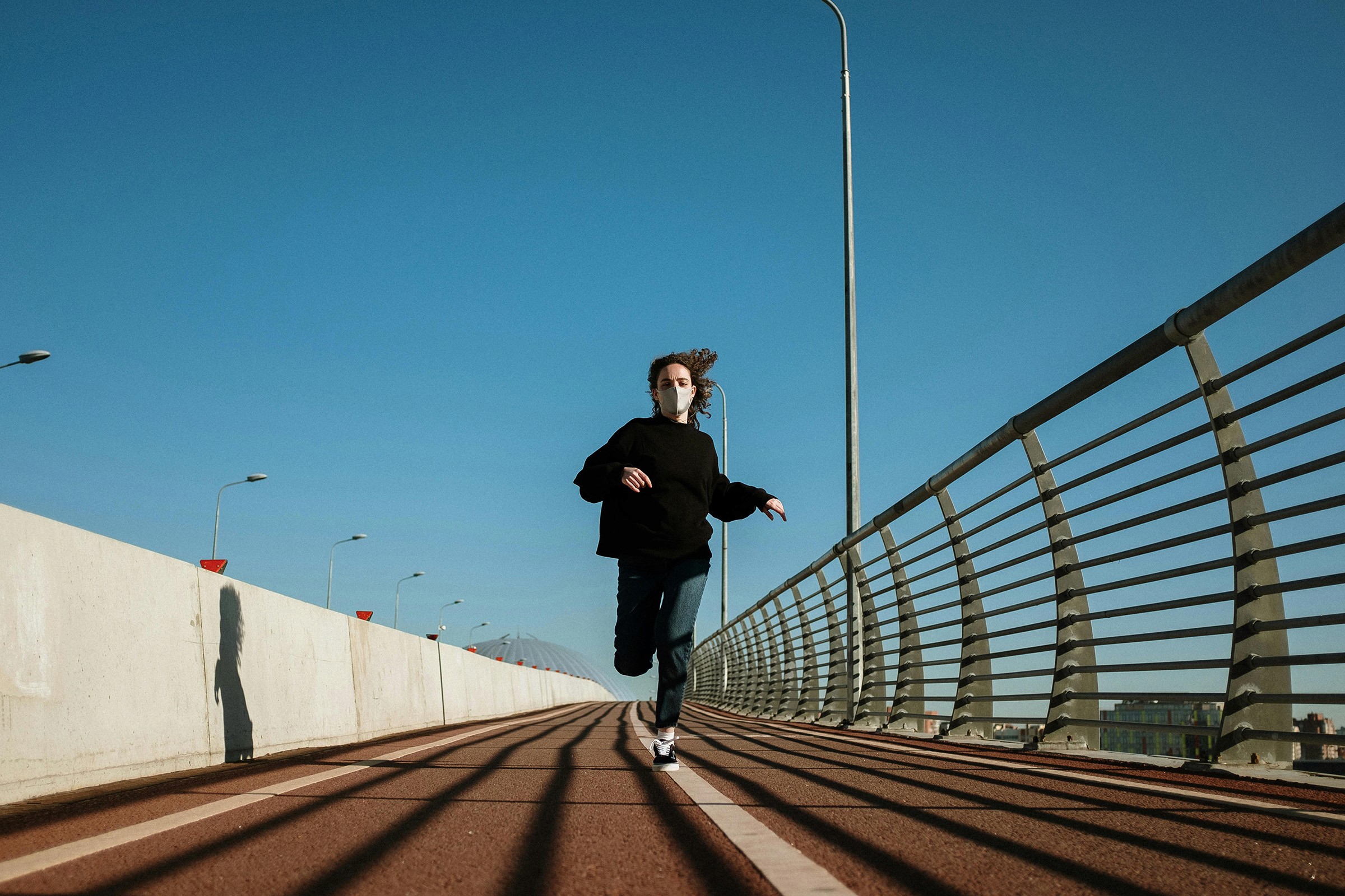 Girl running on a bridge