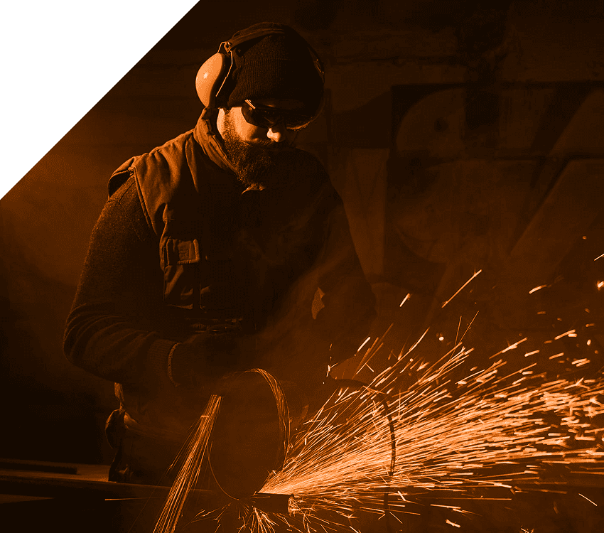 Guy welding with noise-canceling headphones on