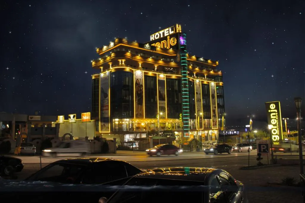 Hotel Gorenje in Pristina, Kosovo, captured at night with dynamic light trails and prominent illuminated façade elements. Terraplan Partners handled architectural planning and supervision.