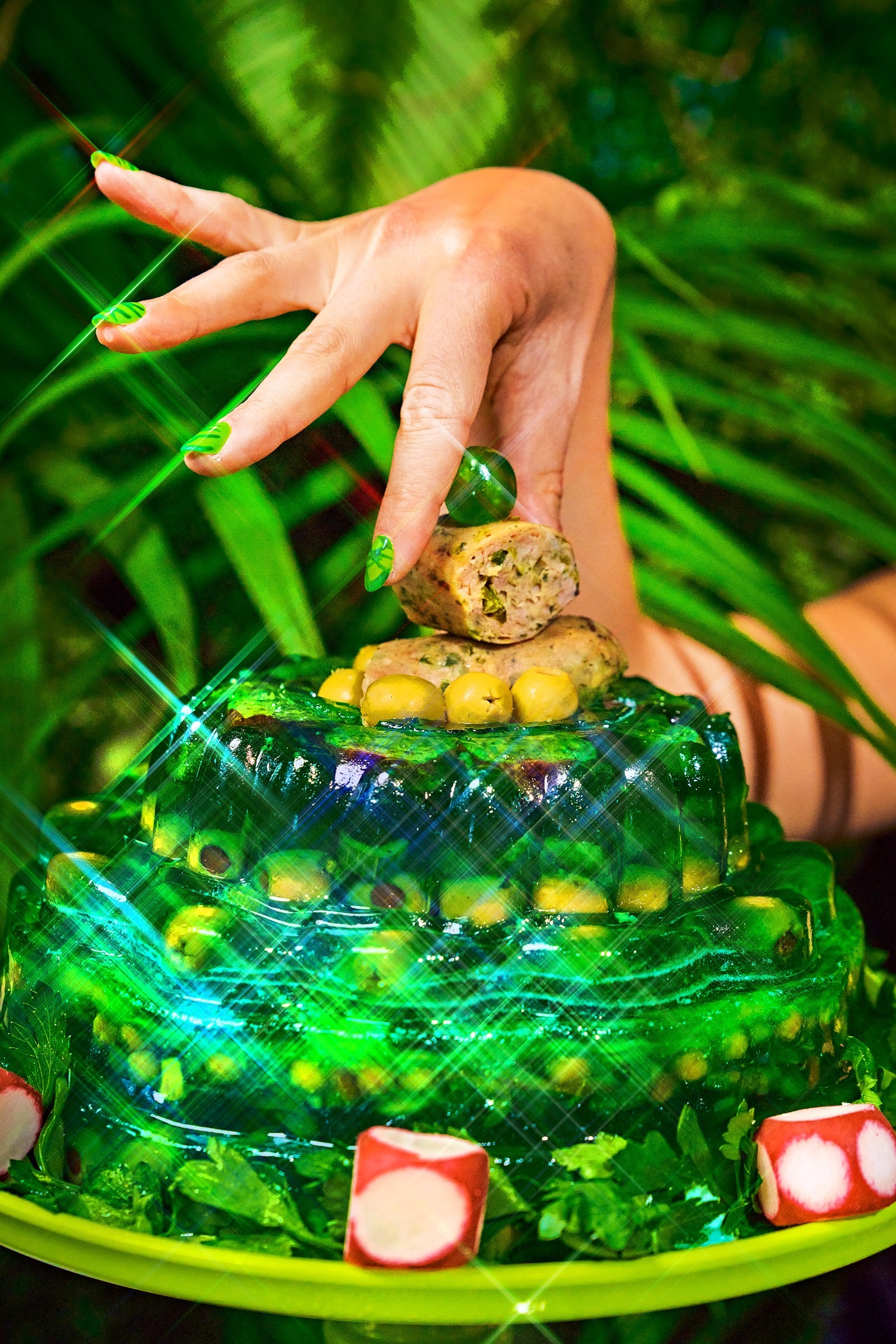A hand lifting the green glass cloche from the campaign display