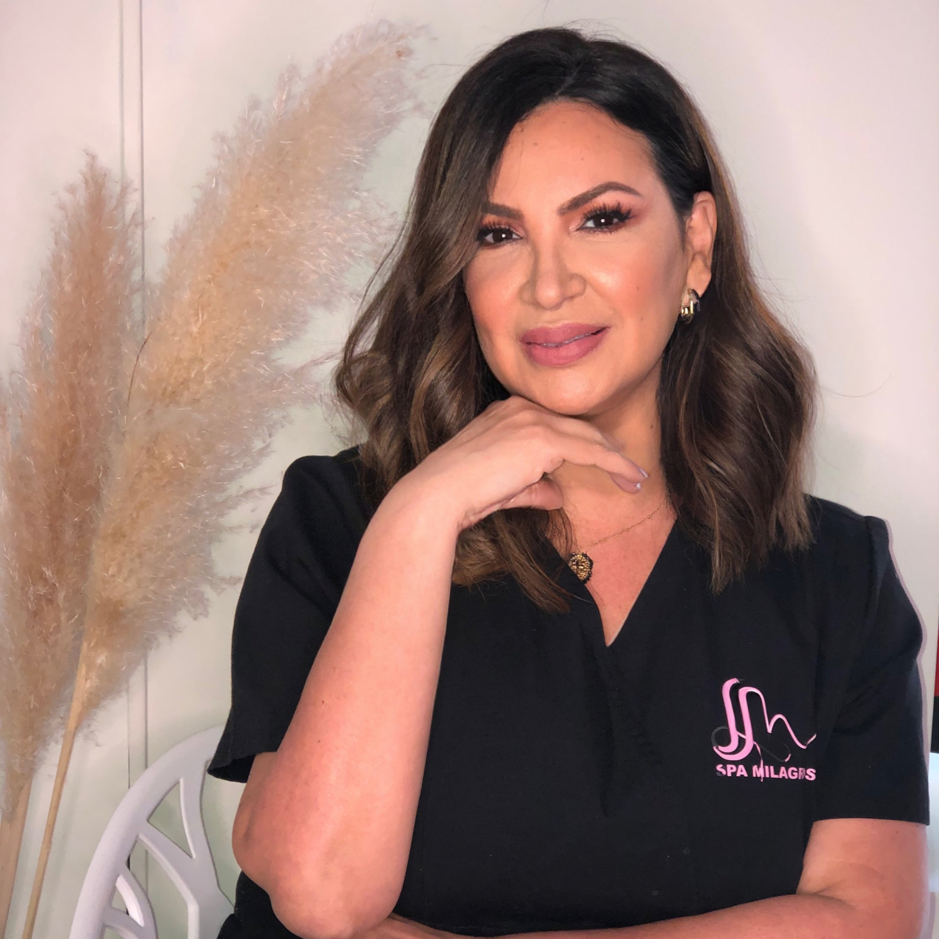 A serene spa setting with two lounge chairs beside a warm, reflective pool and soft, natural lighting.
