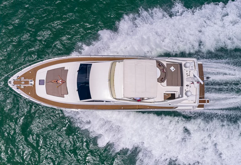 Aft deck of the Ferretti Lumar yacht set for dining with seating for 8 guests.