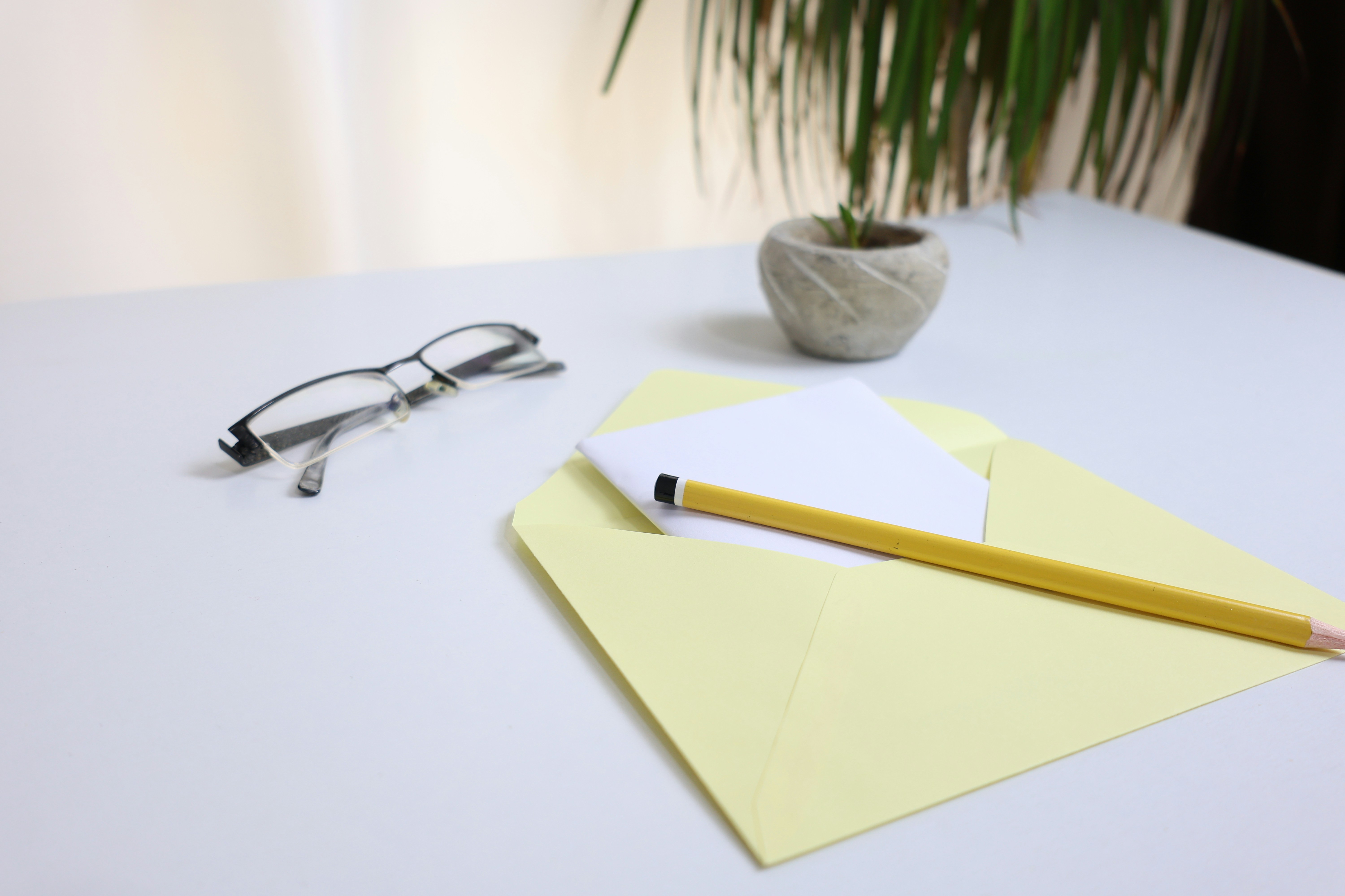Yellow envelope and pencil on a desk, symbolizing a written demand letter.