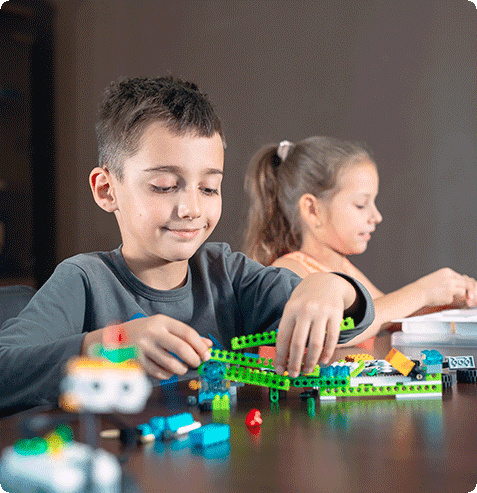 Kids designing creative engineering projects in school-based LEGO building class