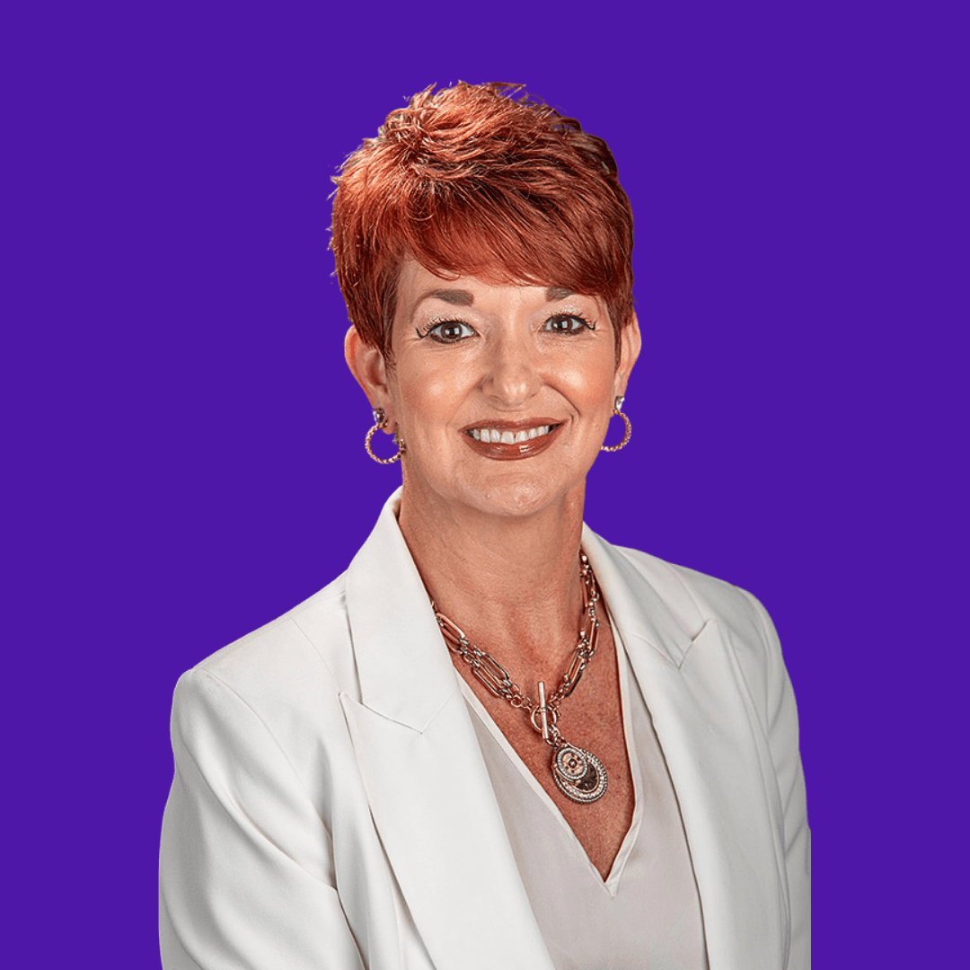 Profile portrait of a man in a white shirt against a light background