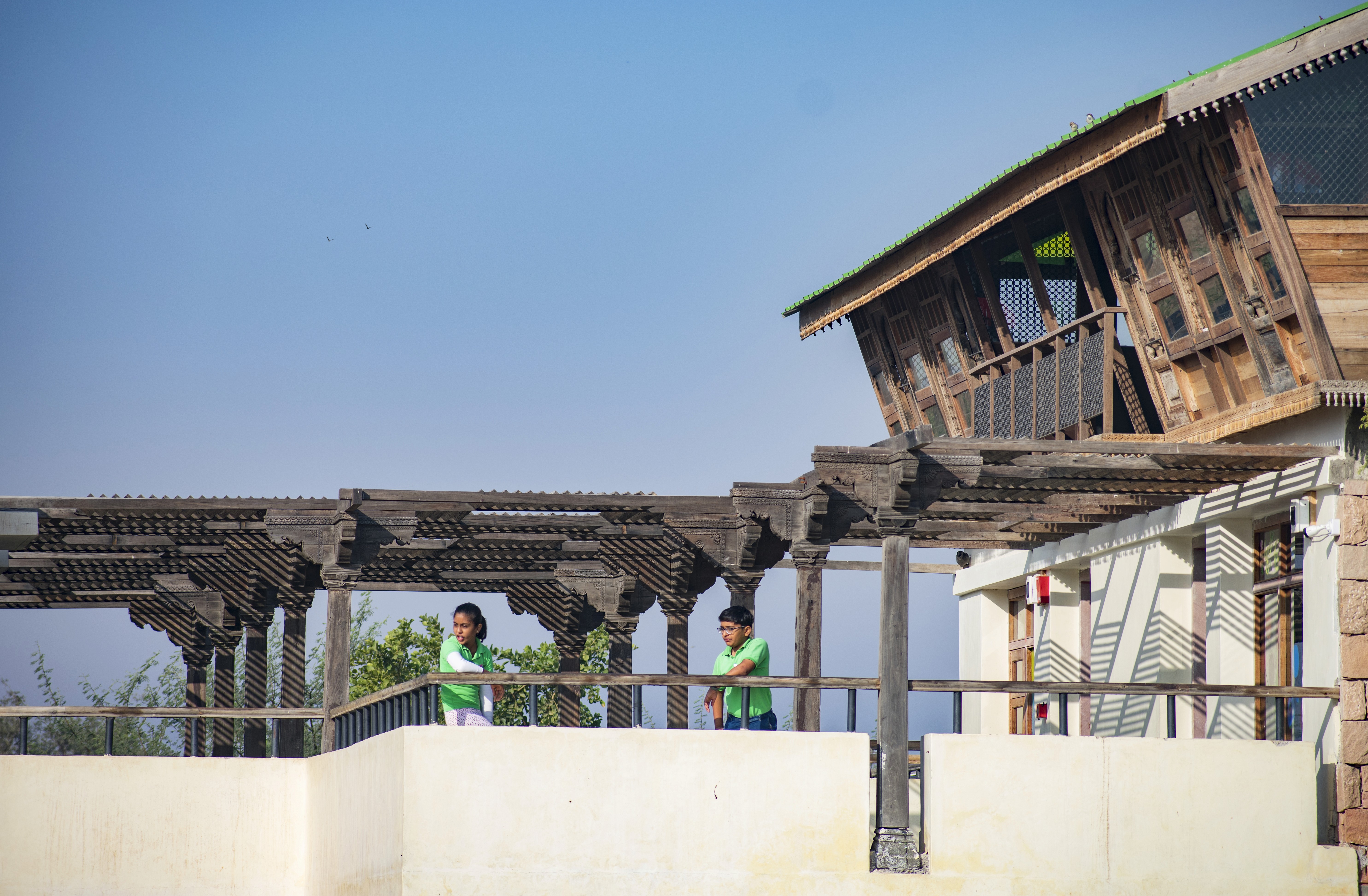 A student is writing in a notebook, concentrating on her work
