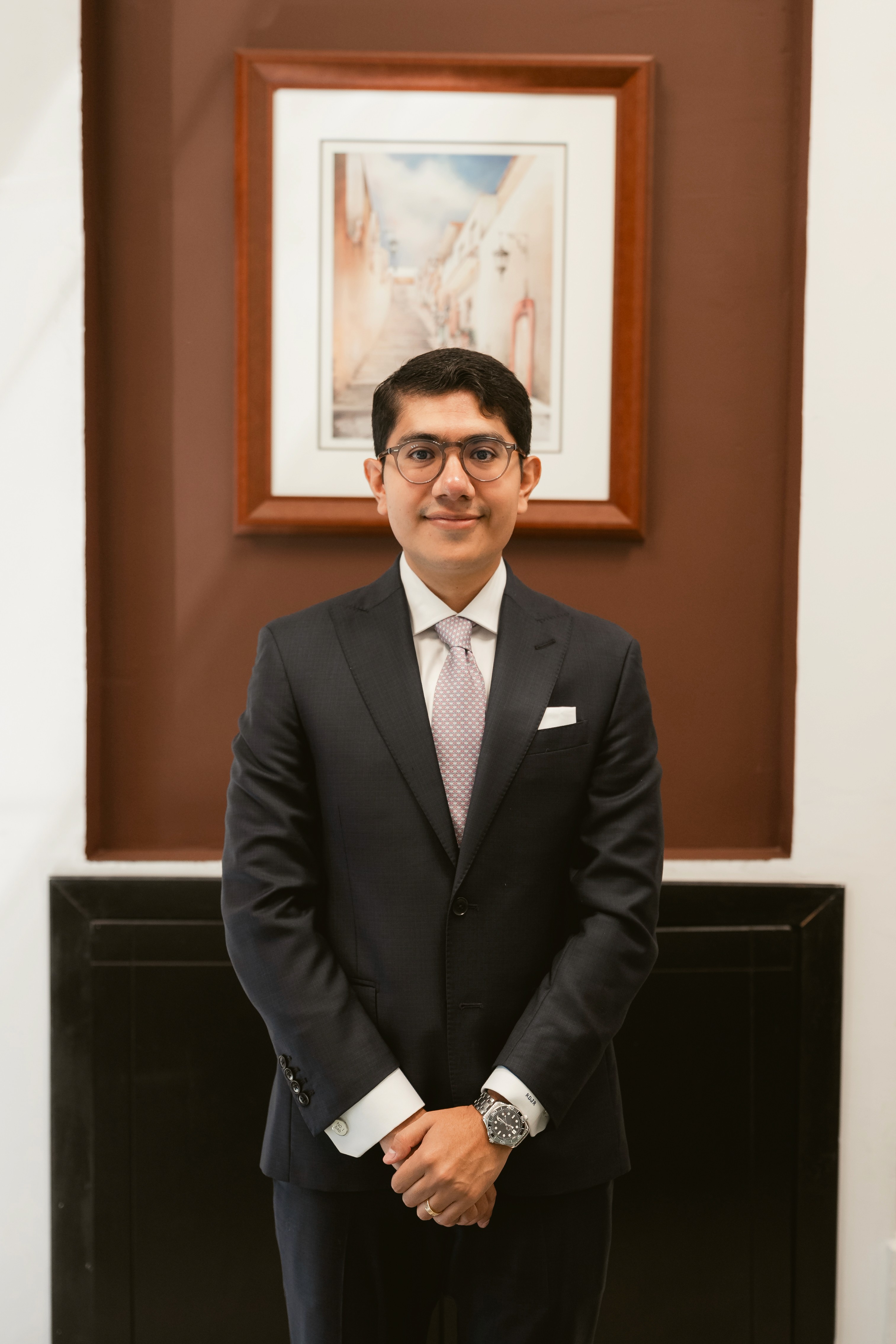 a man in a suit standing with his arms crossed