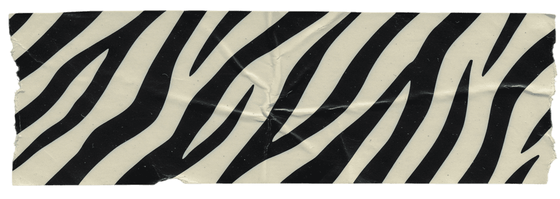 A piece of decorative tape featuring a black and white zebra stripe pattern, slightly crumpled and textured, adding a stylish, animal print accent.