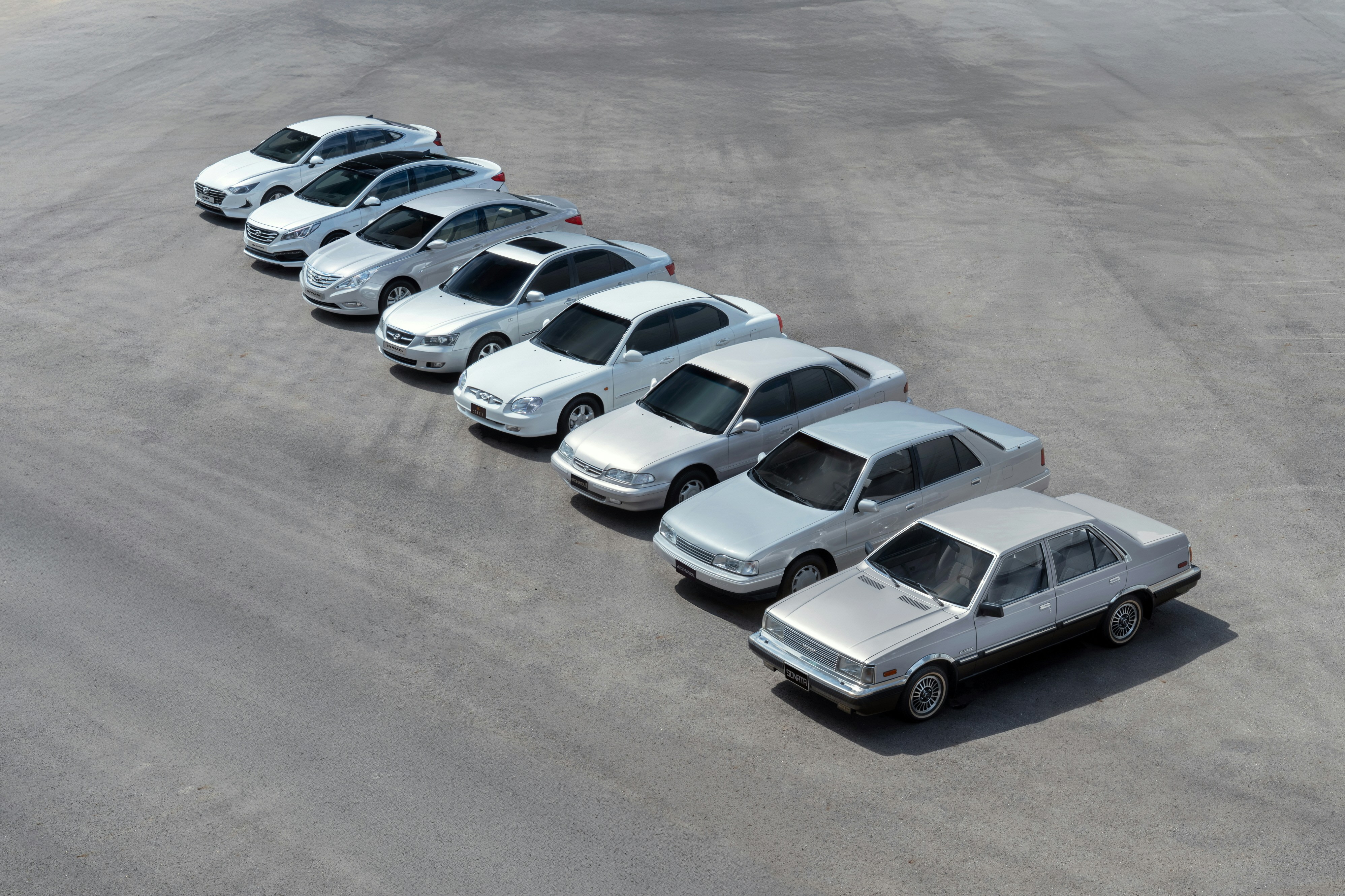 Several silver sedans parked in a row.