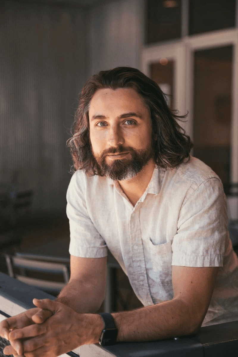 "Portrait of Adel Al-Kuwari, a professional couples therapist, sitting indoors and looking at the camera."