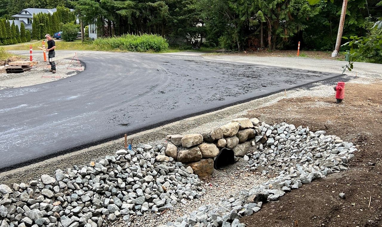 Stormwater culvert and riprap drainage system construction at Castle Road subdivision entrance