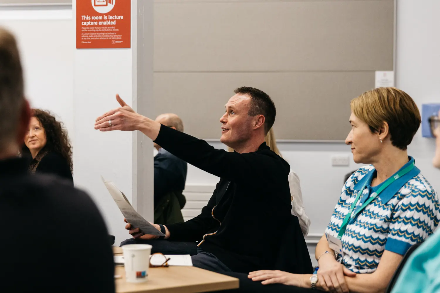 People sitting and talking in a meeting room.