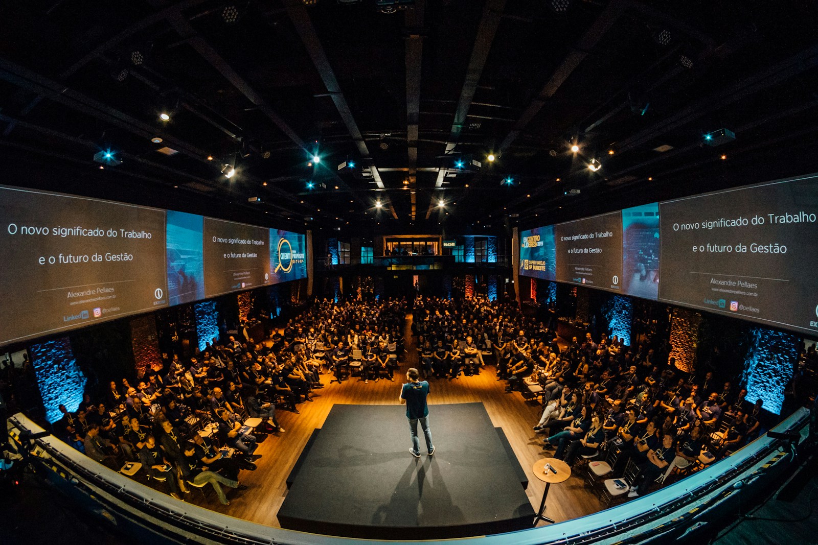Speaker addressing a large audience at a healthcare leadership event