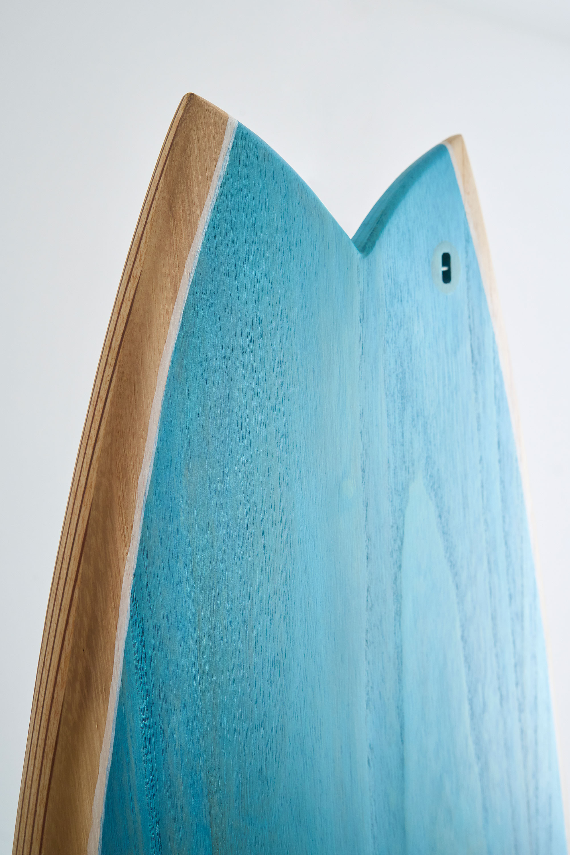 Fish tail of a hand painted timber surfboard