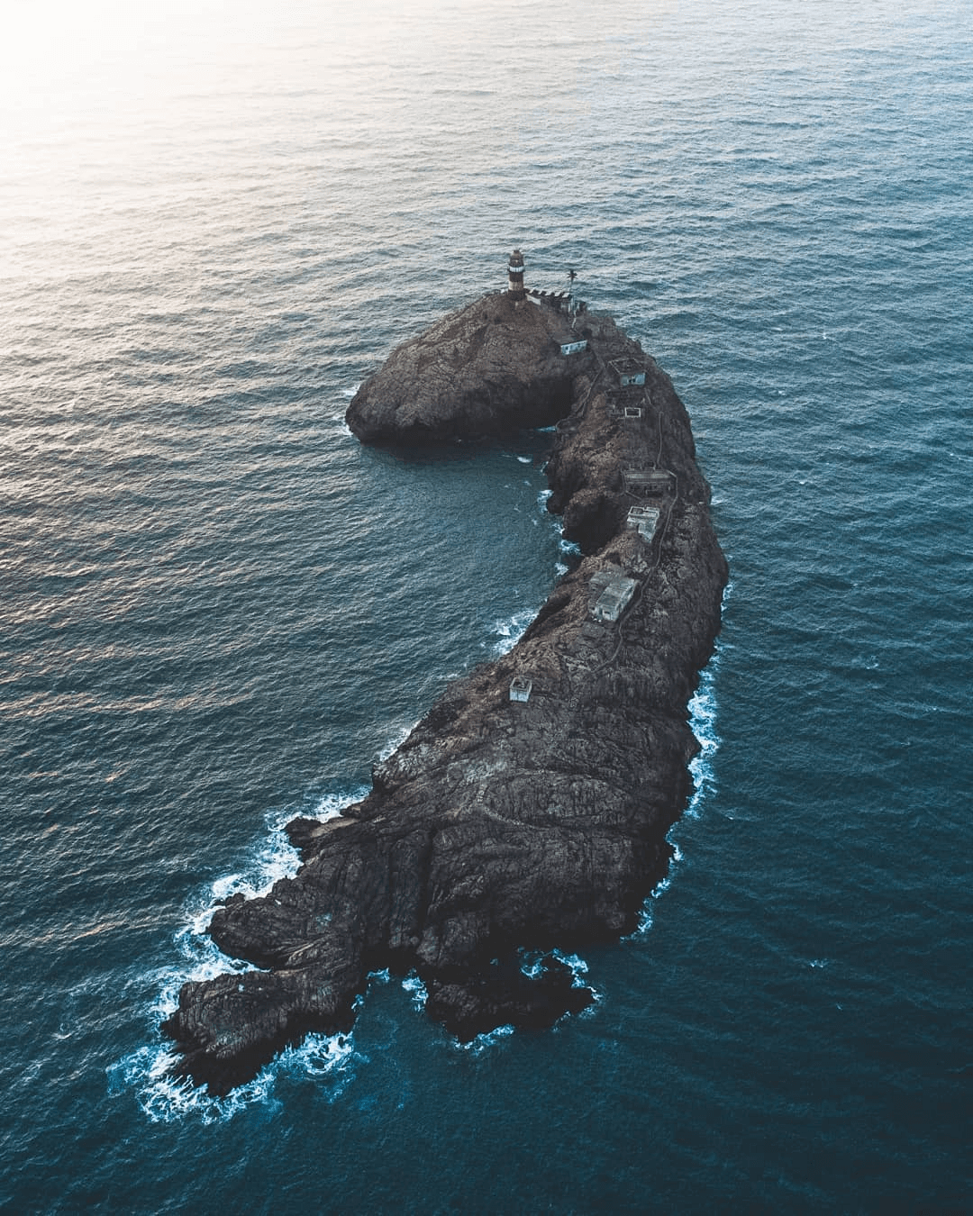 <img src="island.jpg" alt="A serene small island surrounded by crystal-clear blue ocean water under a bright sky">