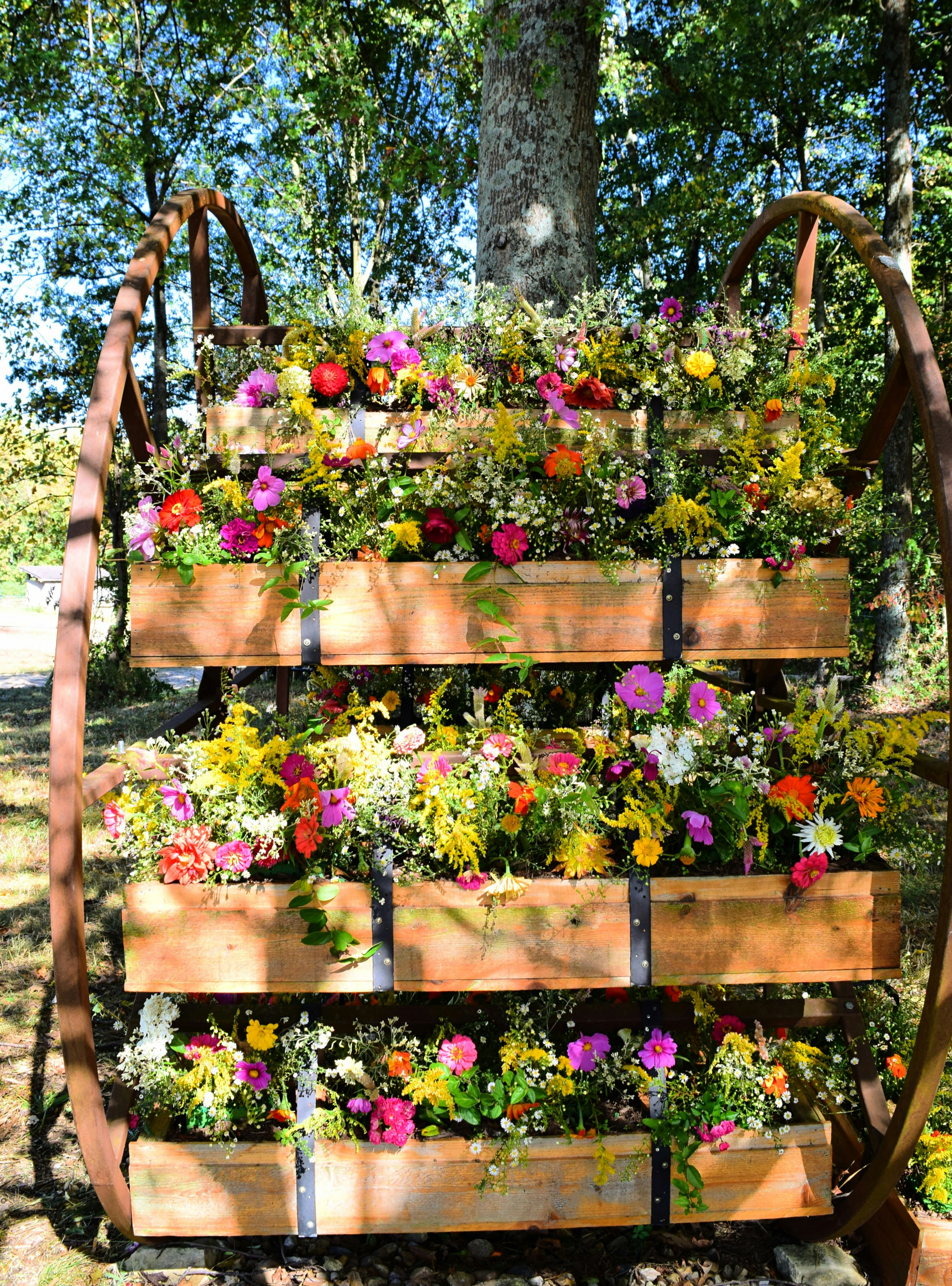 a wooden planter filled with lots of flowers