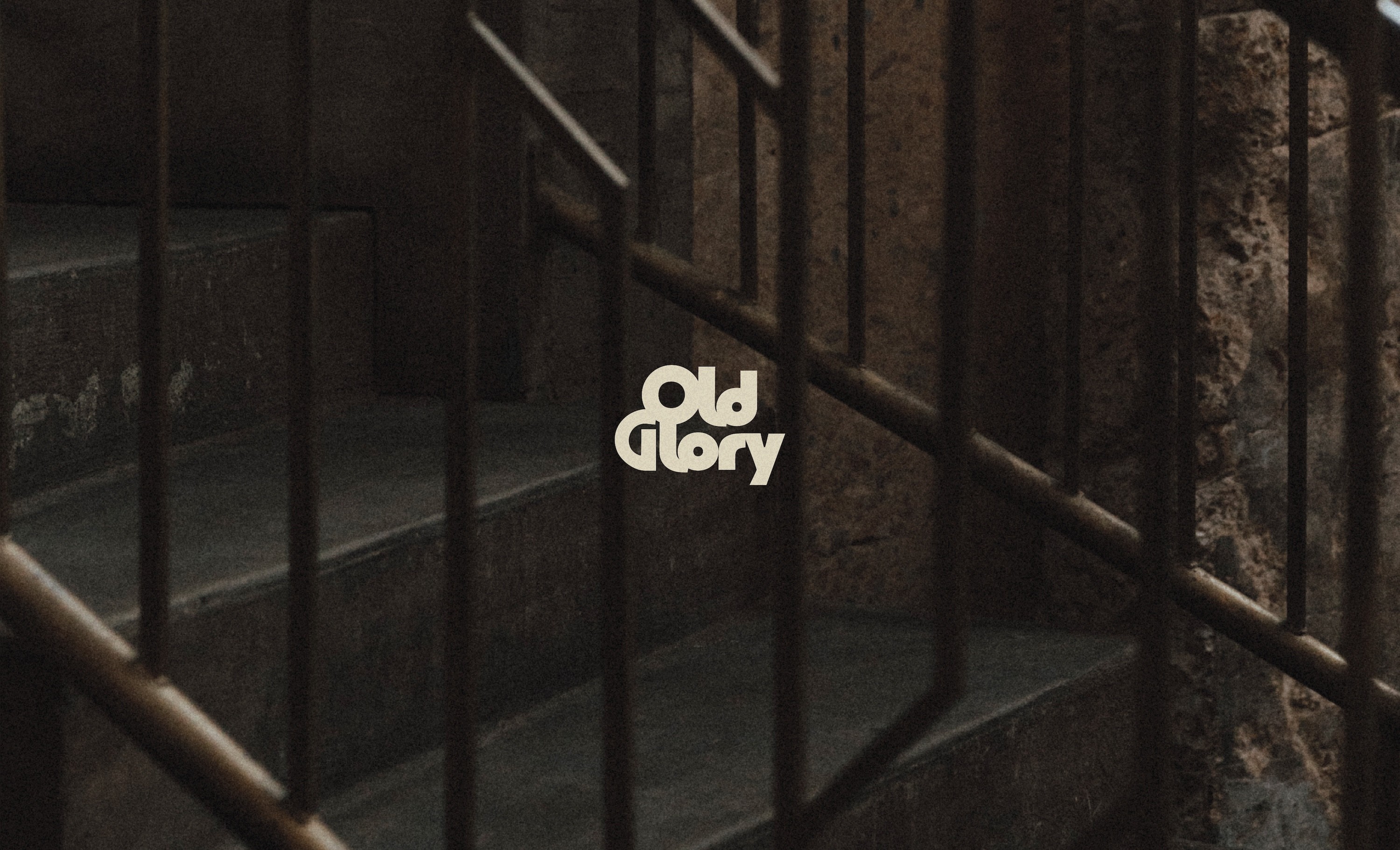Old Glory logo on a dark staircase