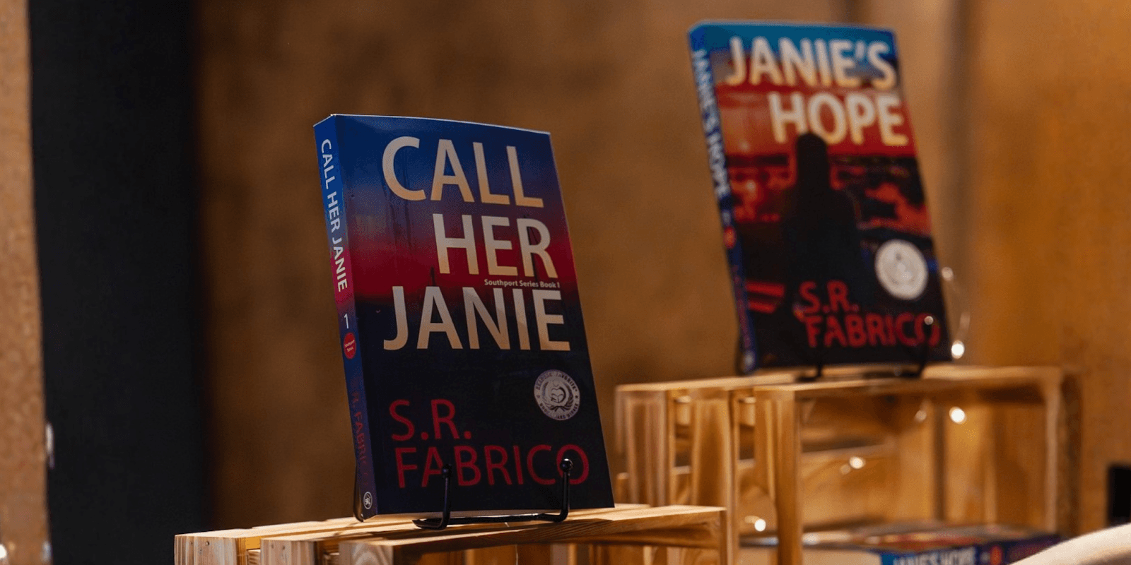 "Call Her Janie" and "Janie's Hope" books by S.R. Fabrico displayed in a promotional setting.
