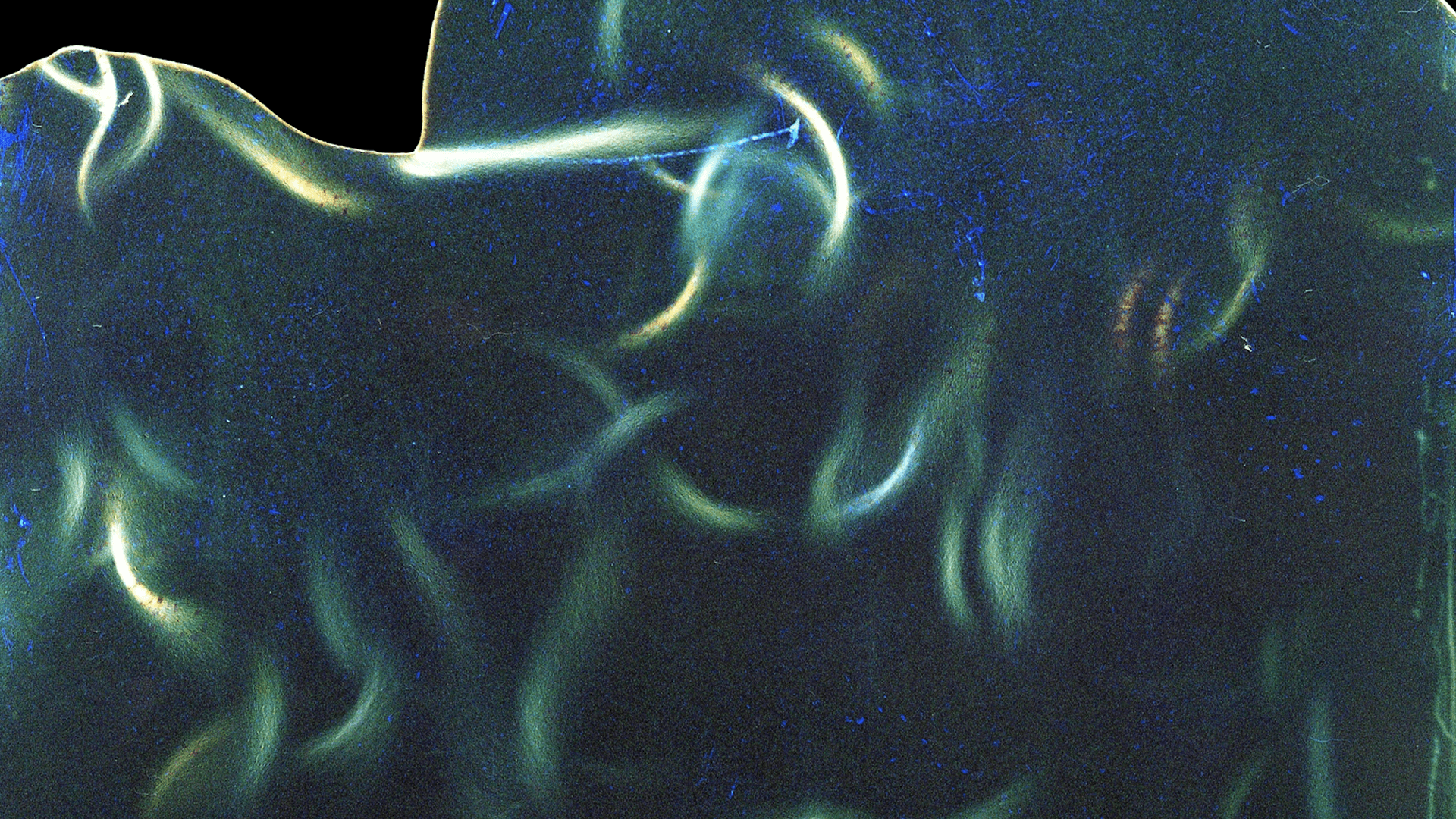 Abstract, motion-blurred image with blue and green tones, creating a sense of movement and depth.