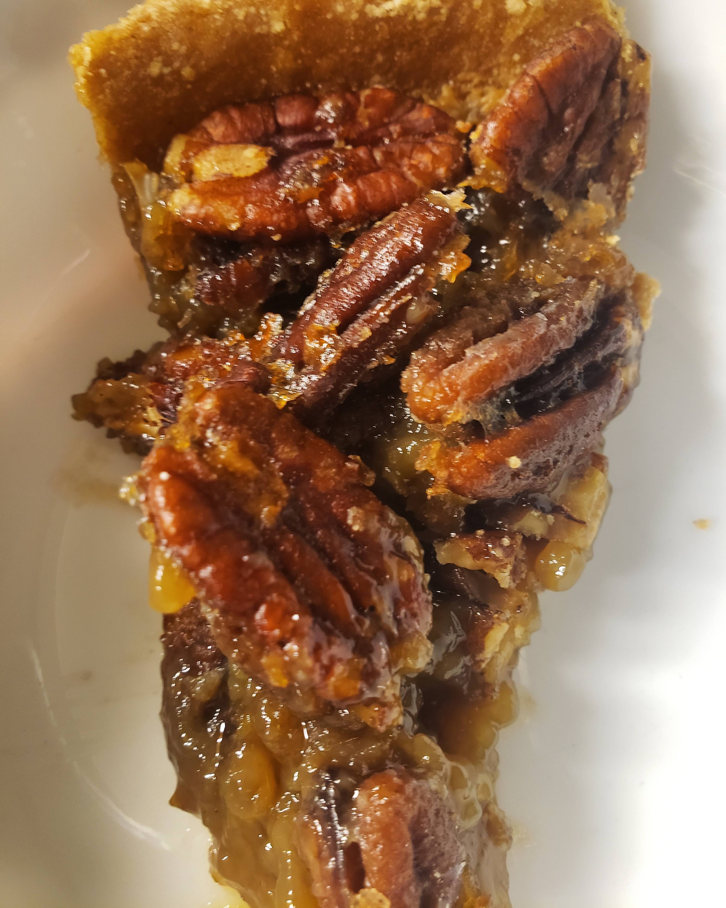 Fresh wild greens and berries in a wooden bowl, representing the hands-on results of Foraging Academy’s certification classes.