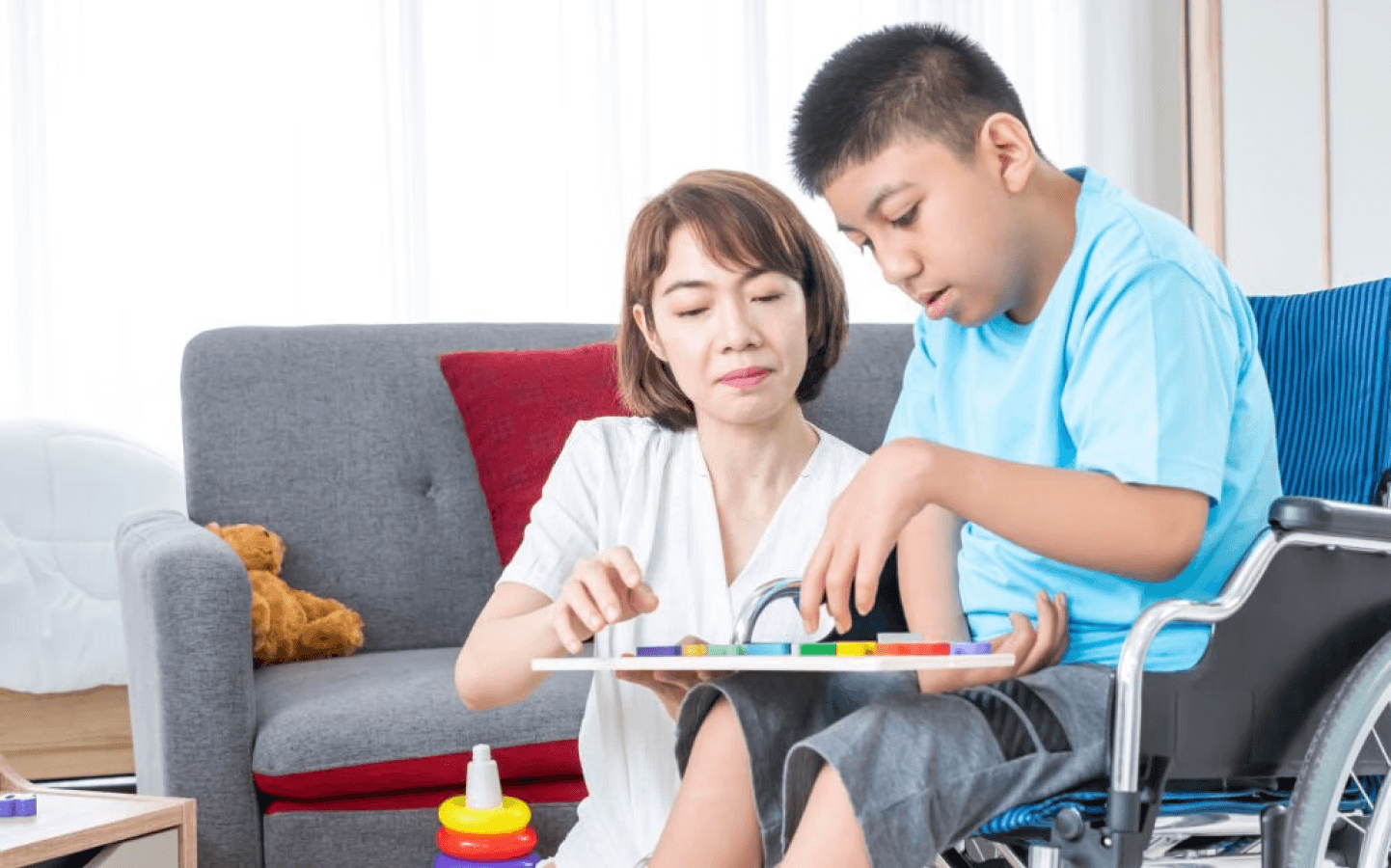 Woman working with a special needs child who is in a wheelchair