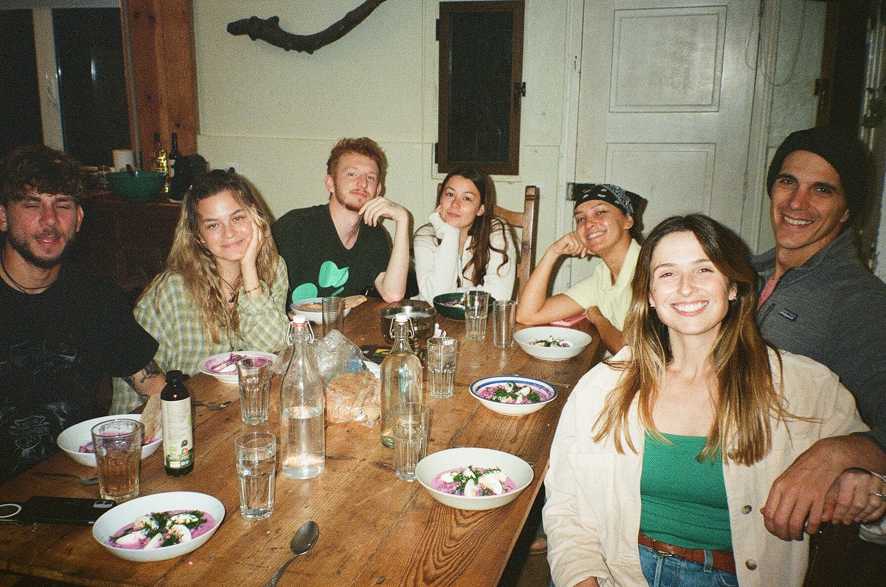 Group of digital nomas enjoying a lively dinner at Wild Souls coliving, a place to cowork in Portugal