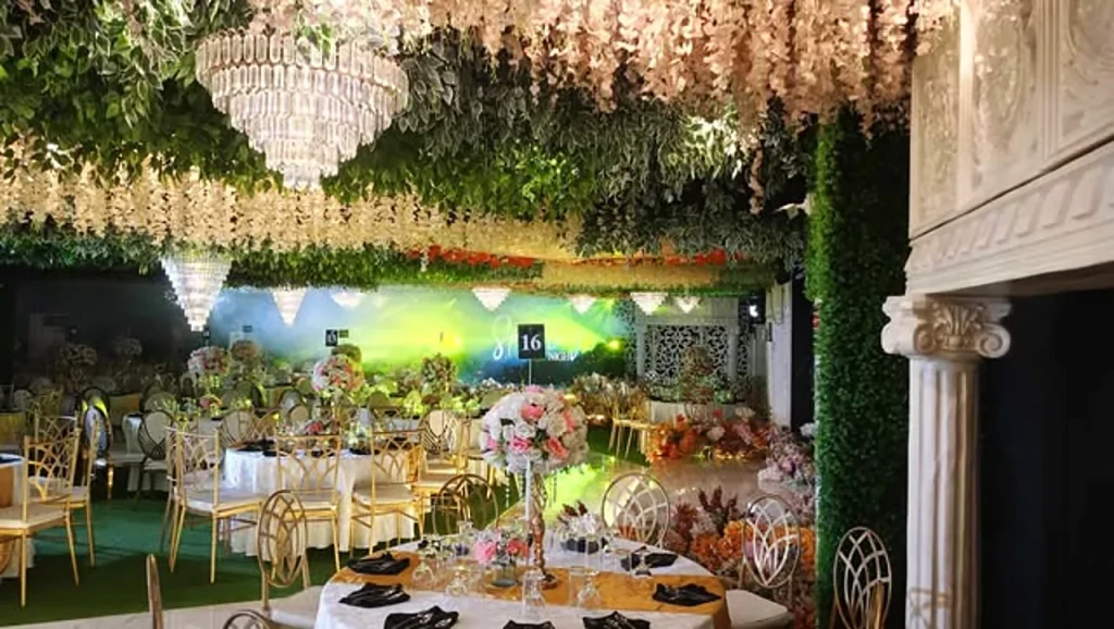 Company event tables under floral chandeliers at Pandora Hall, Stalla Suites QC