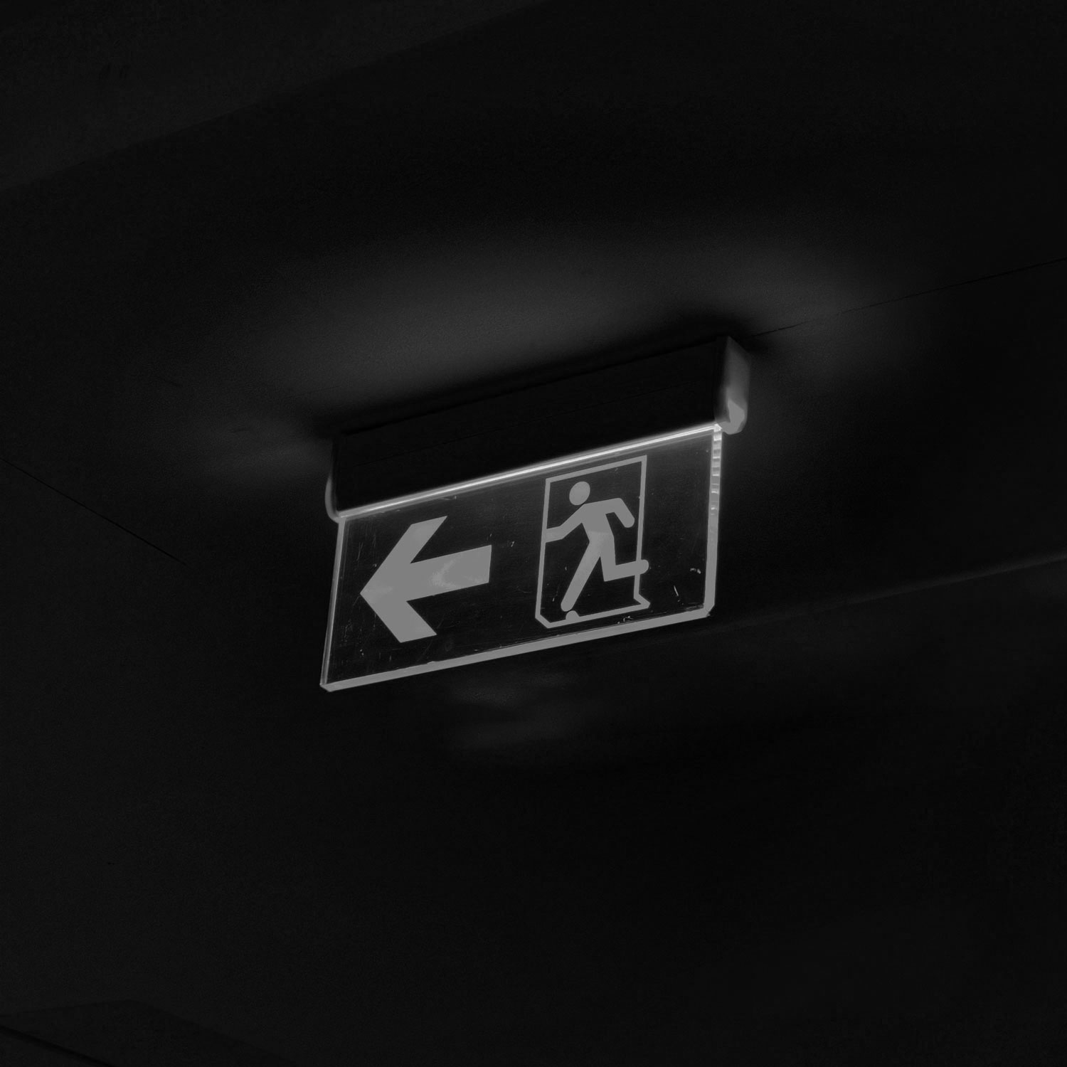 a couple of green signs hanging from the ceiling