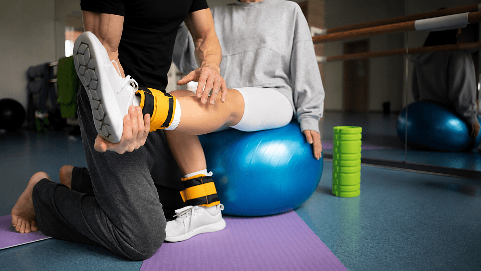 Female athlete undergoing sports injury rehabilitation with guided exercises from a trainer at Ember & Ice Health in Bangalore.